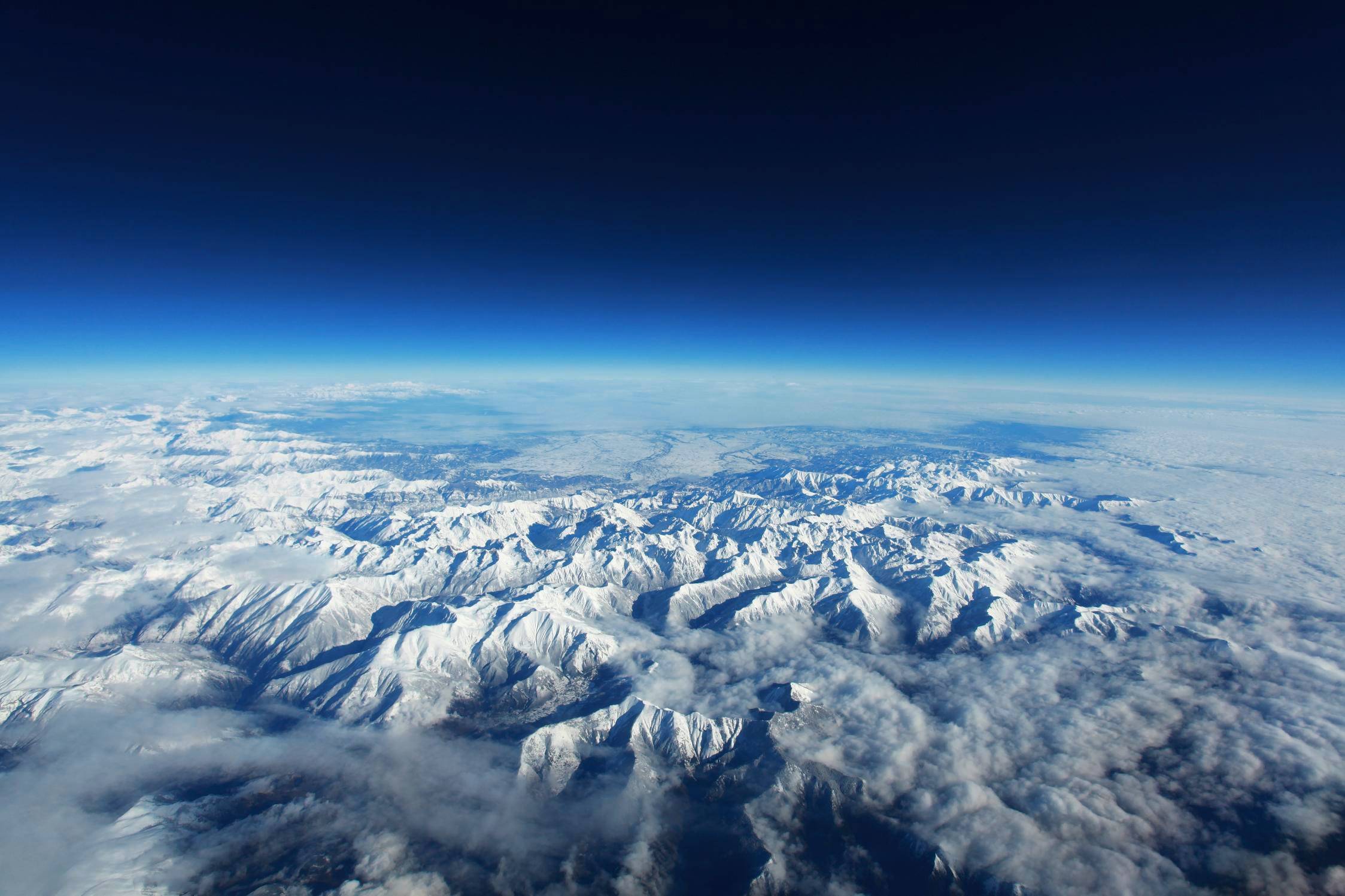 Aerial view of snow-covered Pyrenees mountains HD Wallpaper