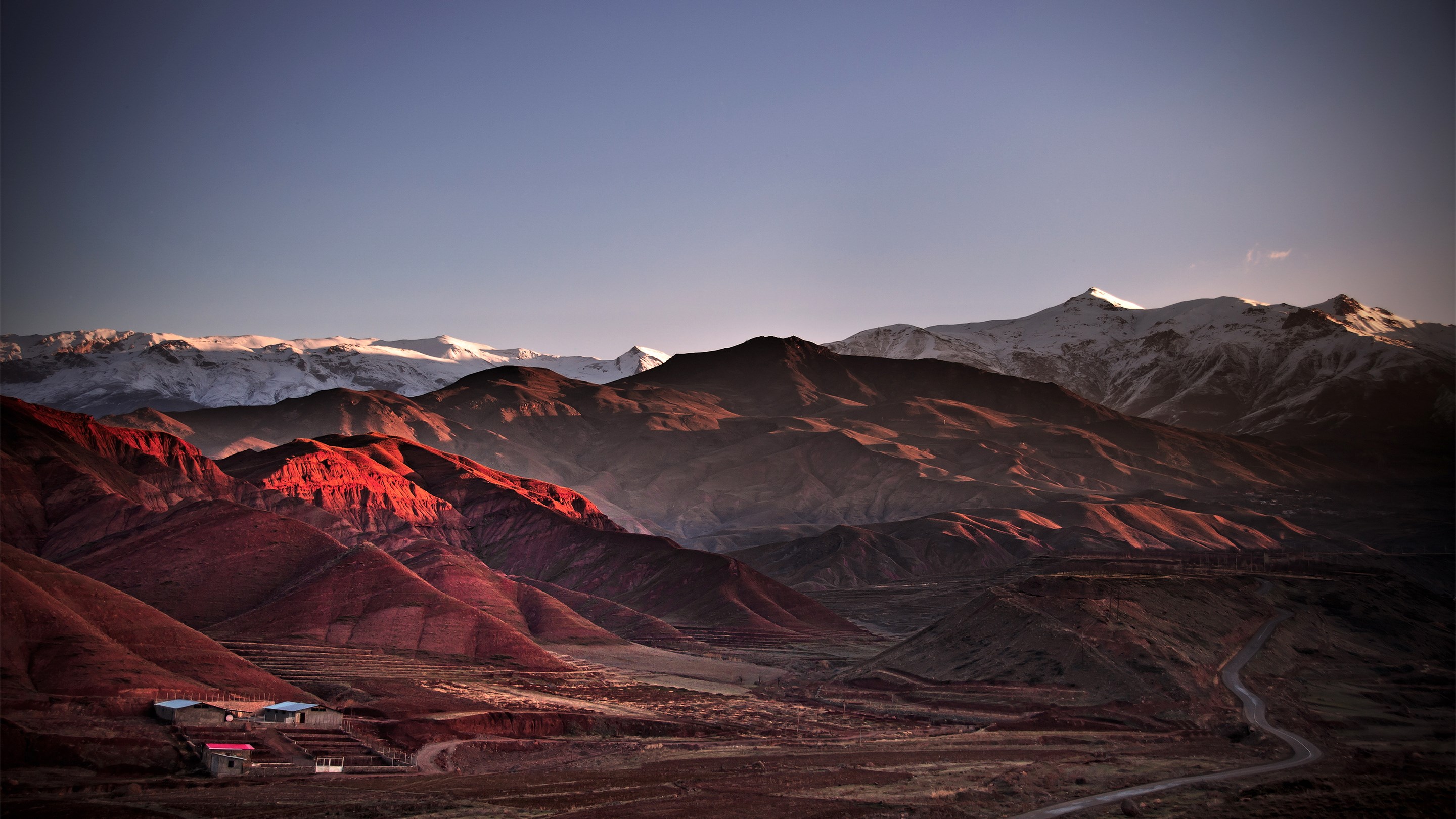 Red mountains and snow-capped peaks at sunset HD Wallpaper