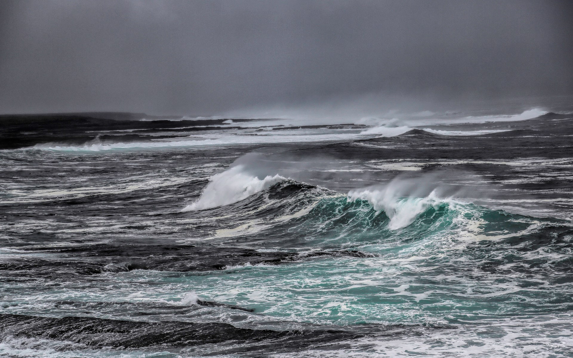 Stormy ocean waves crashing against rocky shores HD Wallpaper