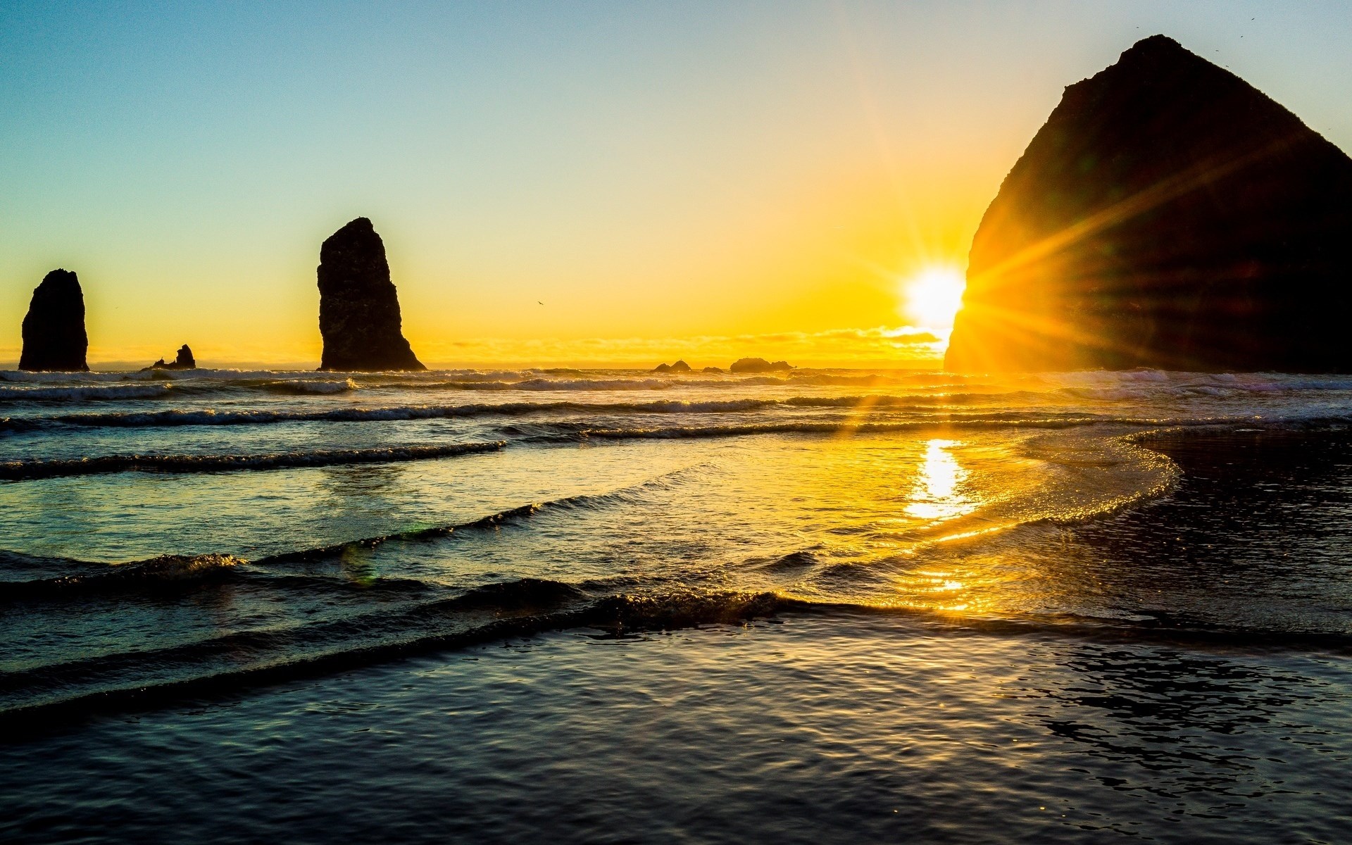 Sunset over Haystack Rock with ocean waves HD Wallpaper