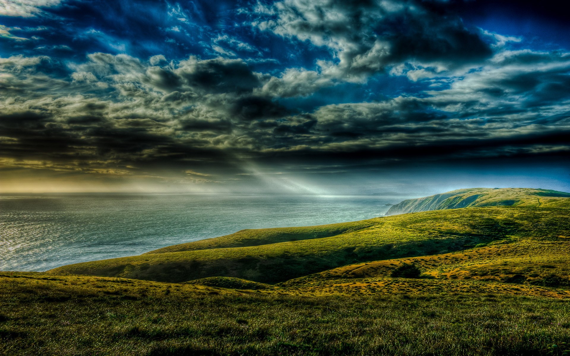 Dramatic sky over a coastal landscape HD Wallpaper