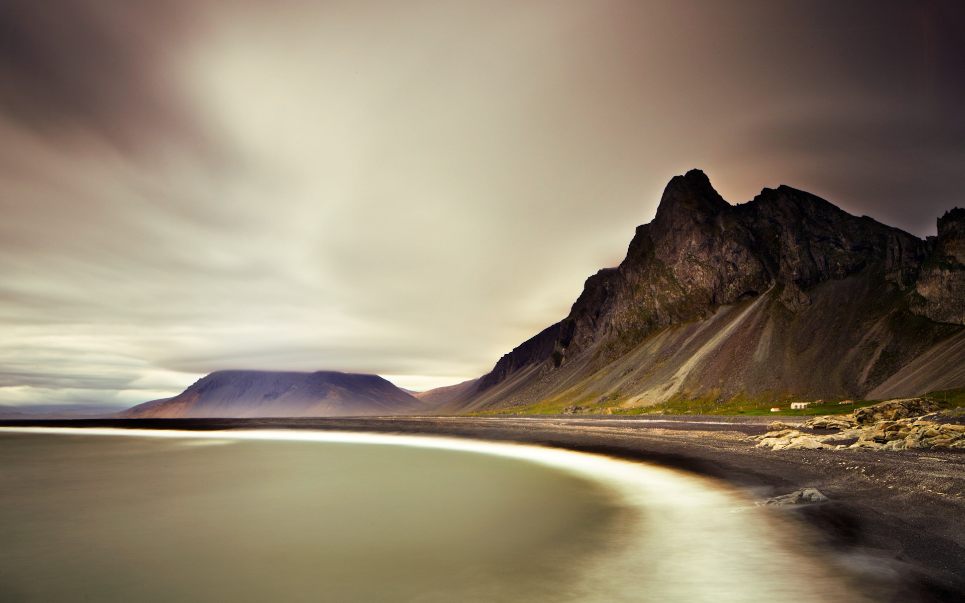 Black sand beach with mountains and ocean HD Wallpaper