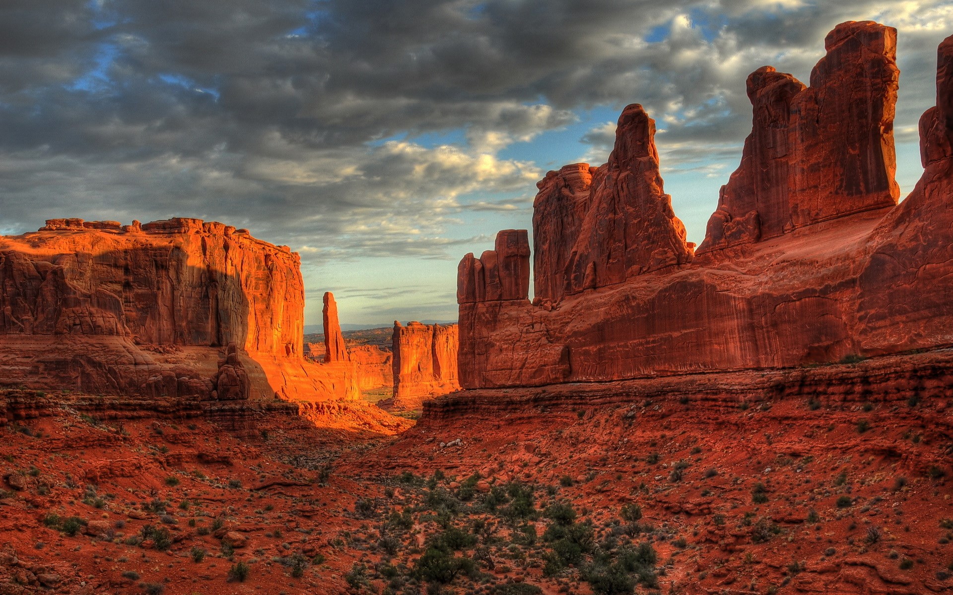 Red rock formations under a cloudy sky at sunset HD Wallpaper