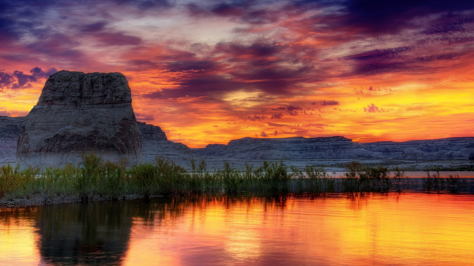 Sunset over a rocky landscape with a lake HD Wallpaper