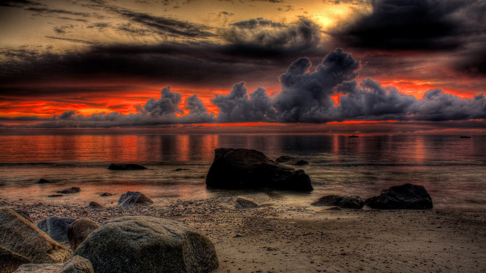 Dramatic sunset over a rocky beach and ocean HD Wallpaper
