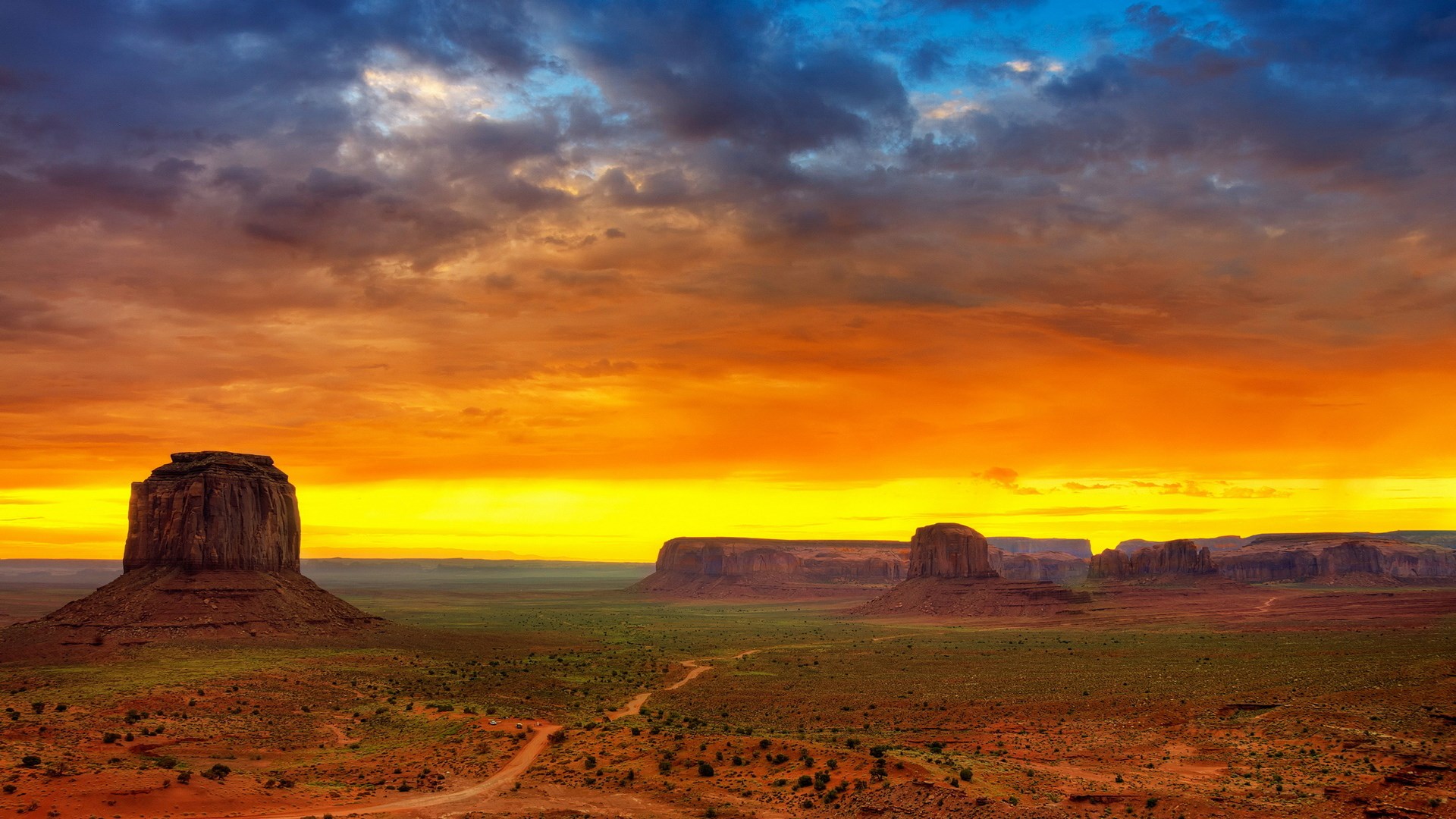 Monument Valley at sunset with dramatic clouds HD Wallpaper