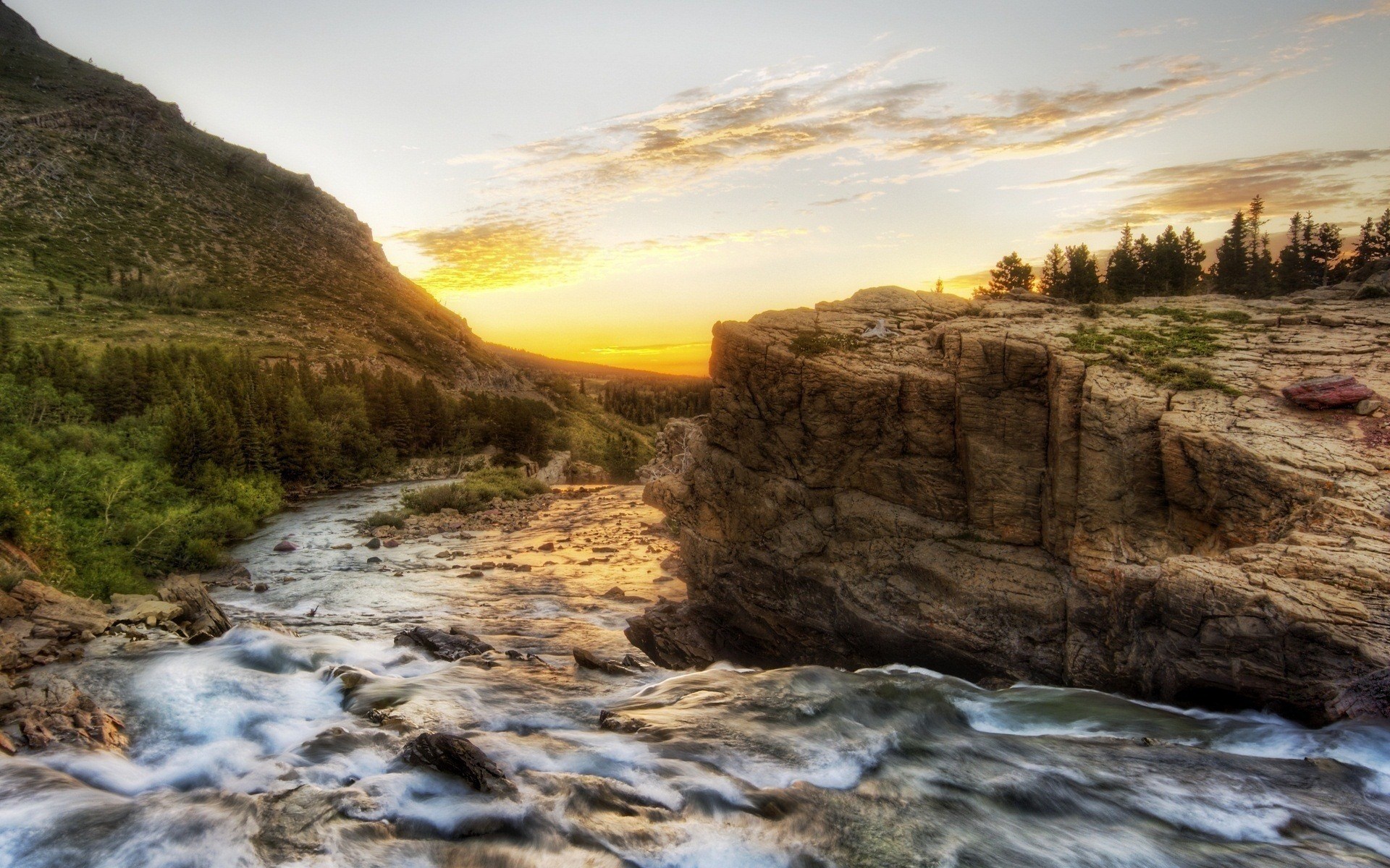 River flowing through a rocky mountain landscape at sunset HD Wallpaper