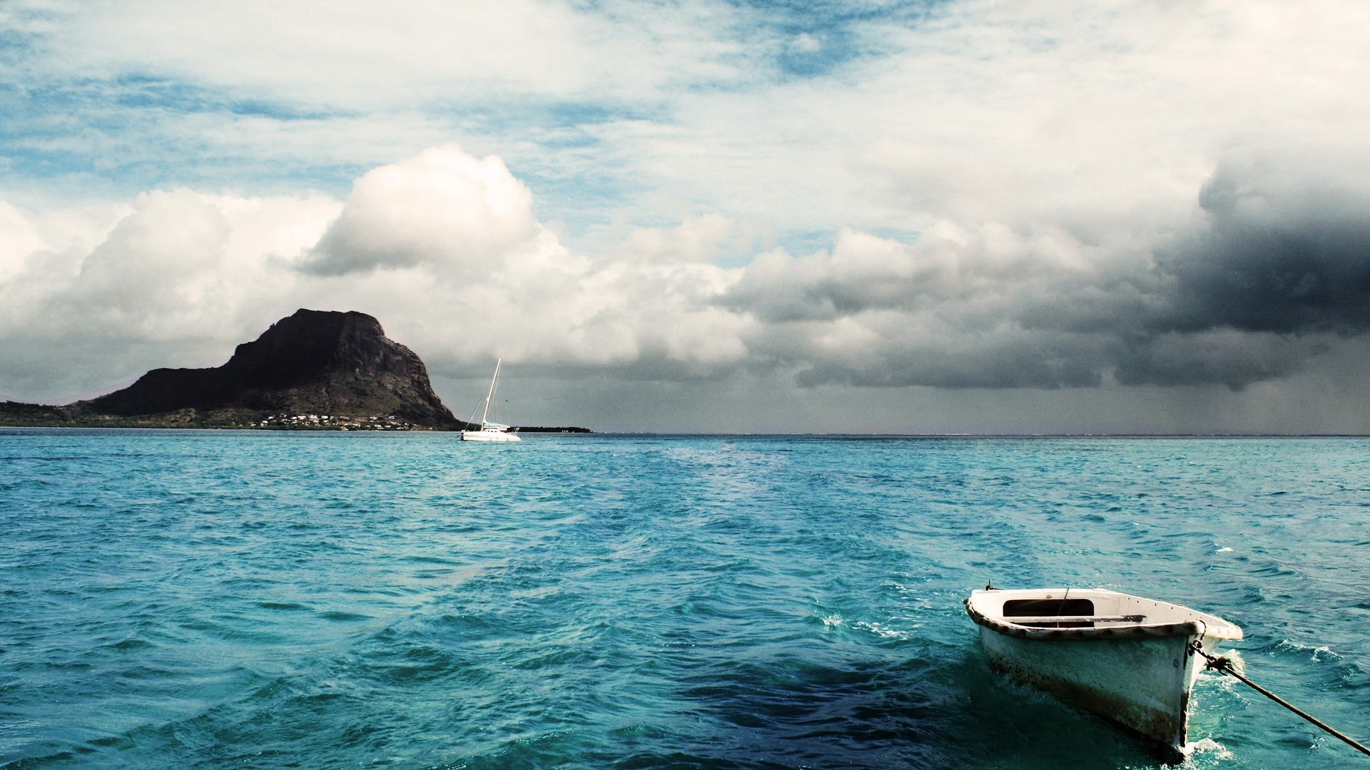 Boat on the water with a mountain island in the background HD Wallpaper