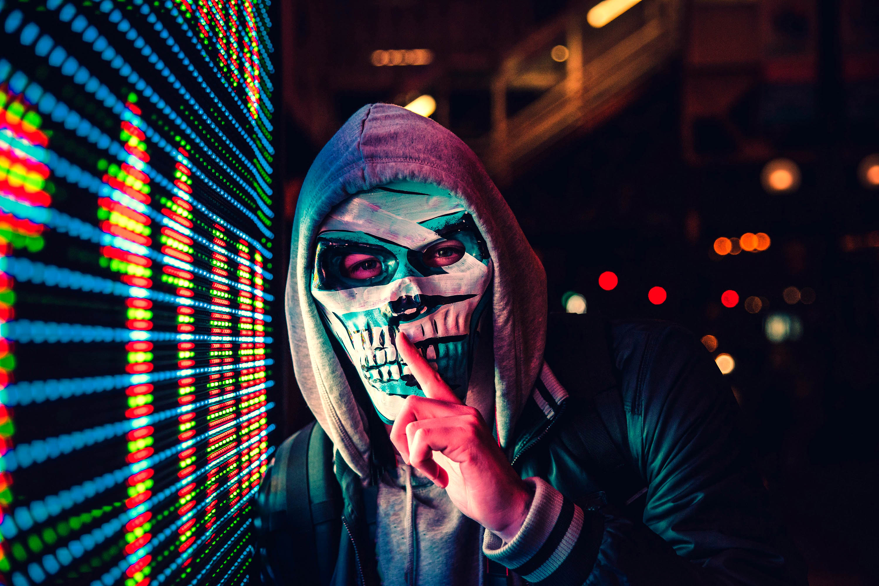 Person in skull mask near digital display HD Wallpaper