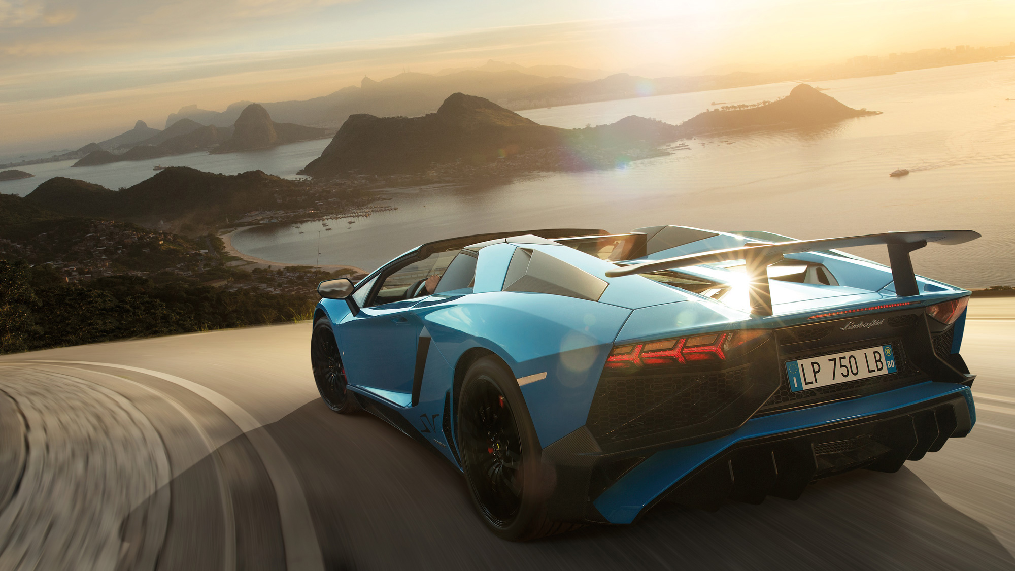 Blue Lamborghini Aventador driving on a scenic road HD Wallpaper