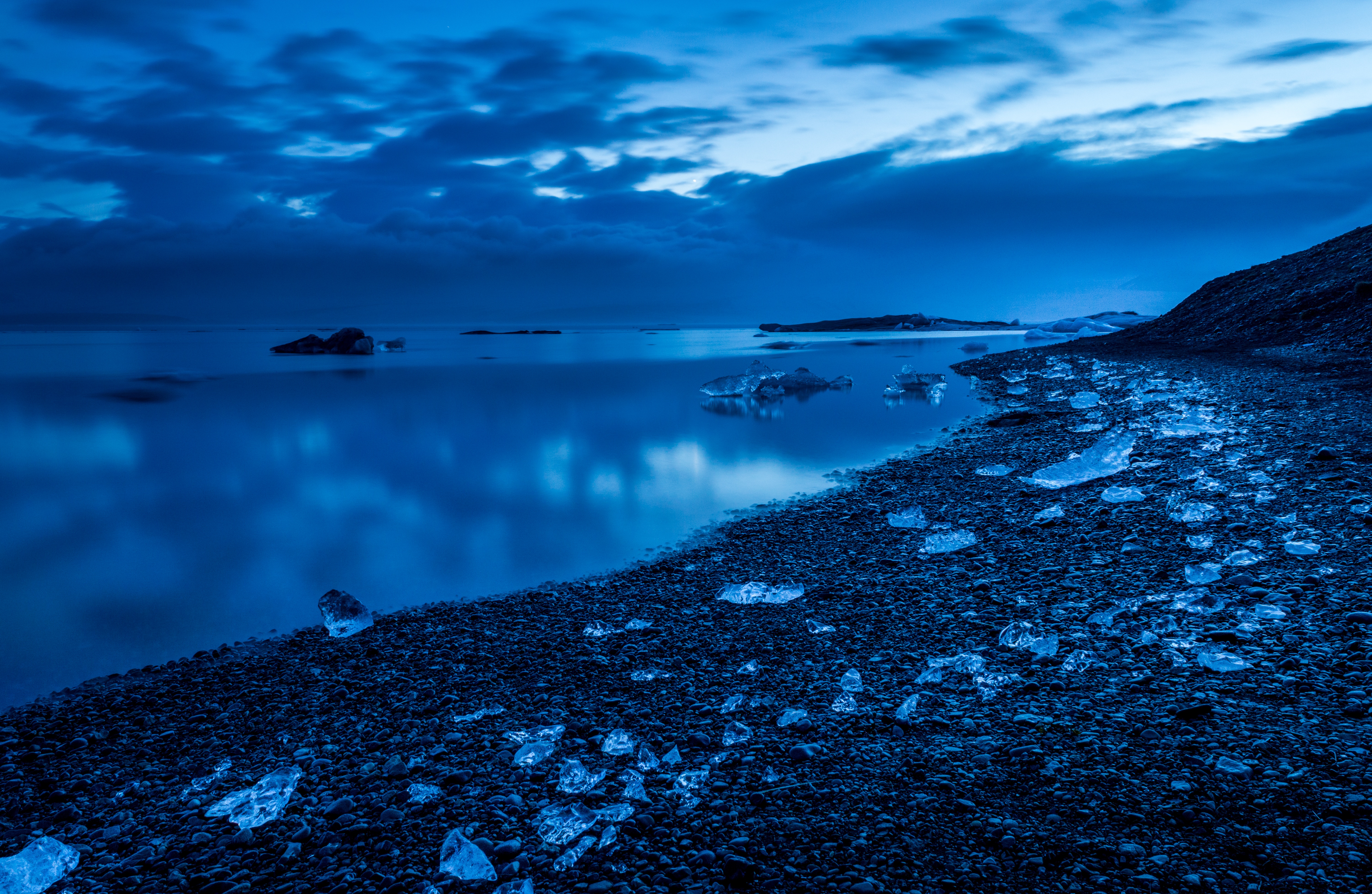 Icebergs on a rocky shore at dusk HD Wallpaper