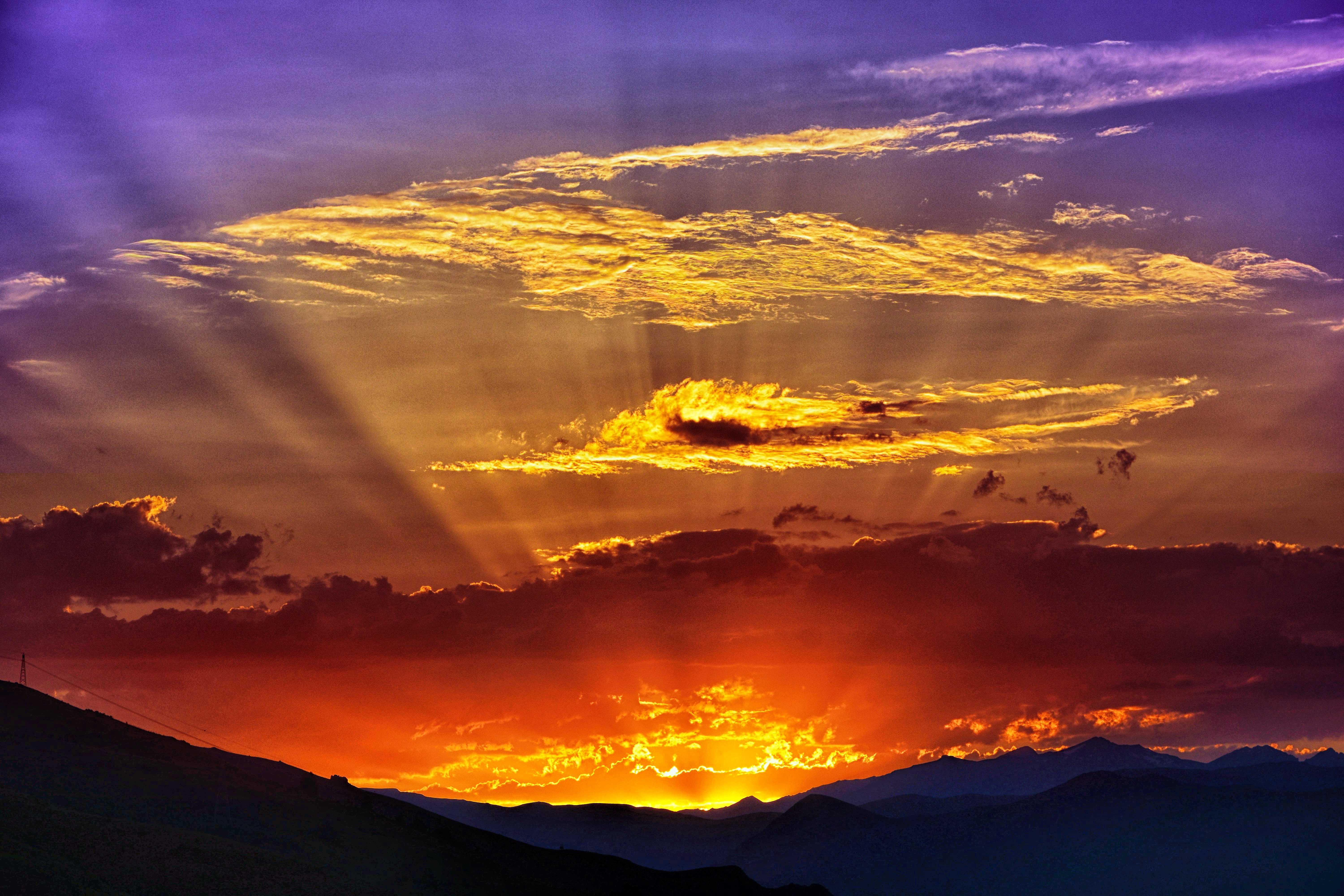 Sunset over mountains with dramatic clouds HD Wallpaper