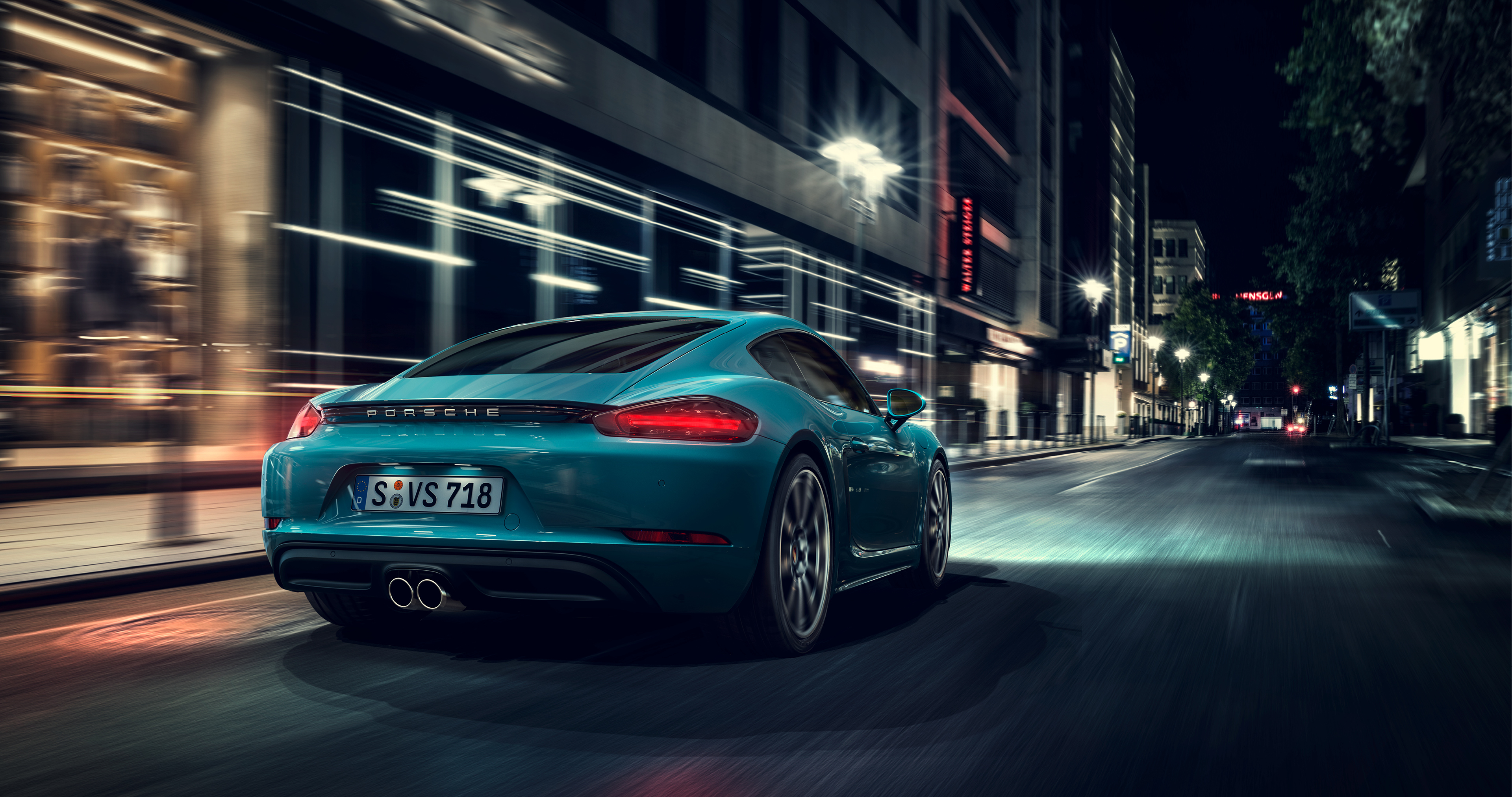 Teal Porsche Cayman Driving Through City at Night HD Wallpaper