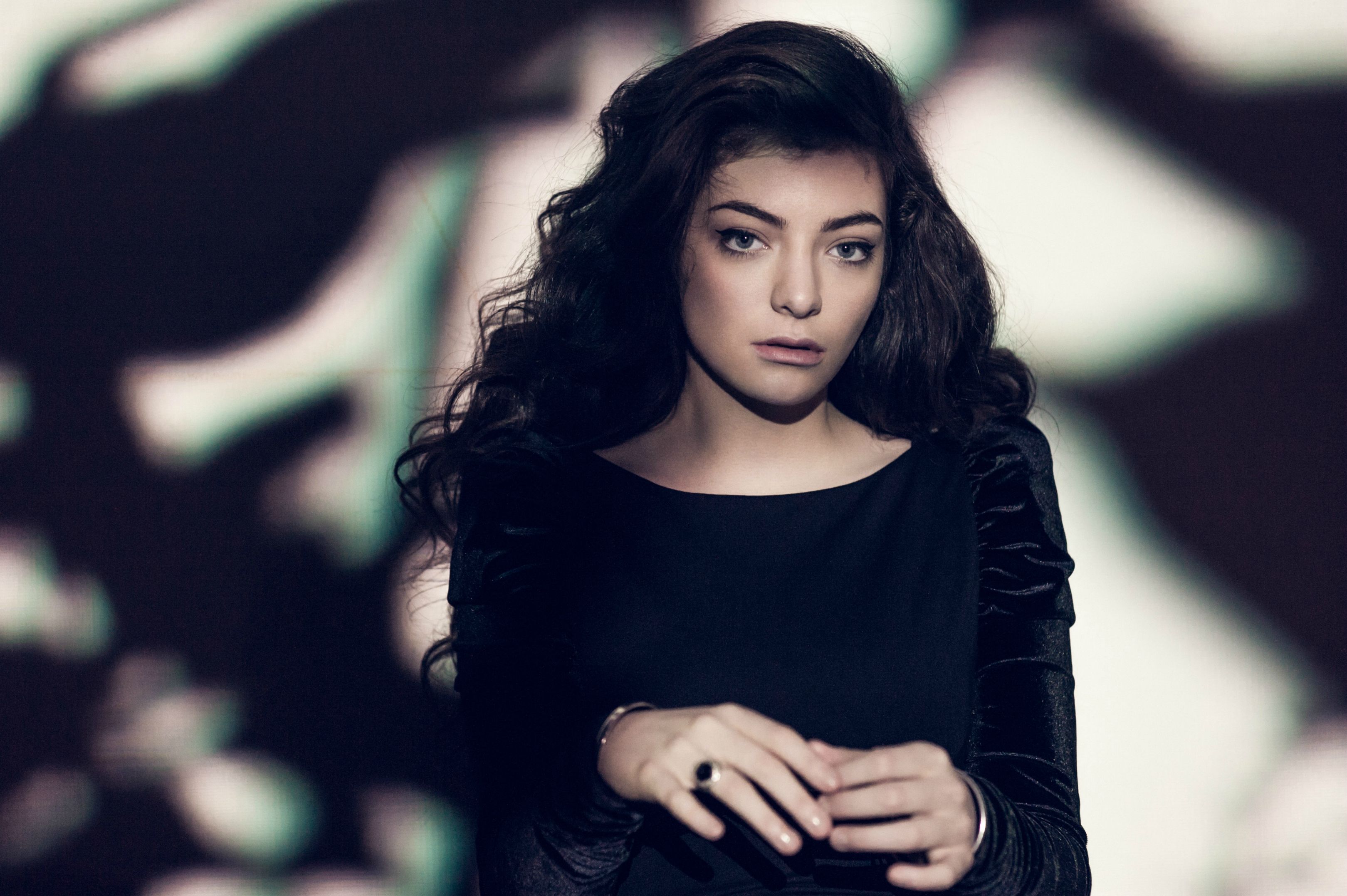 Lorde in a black dress with abstract background HD Wallpaper