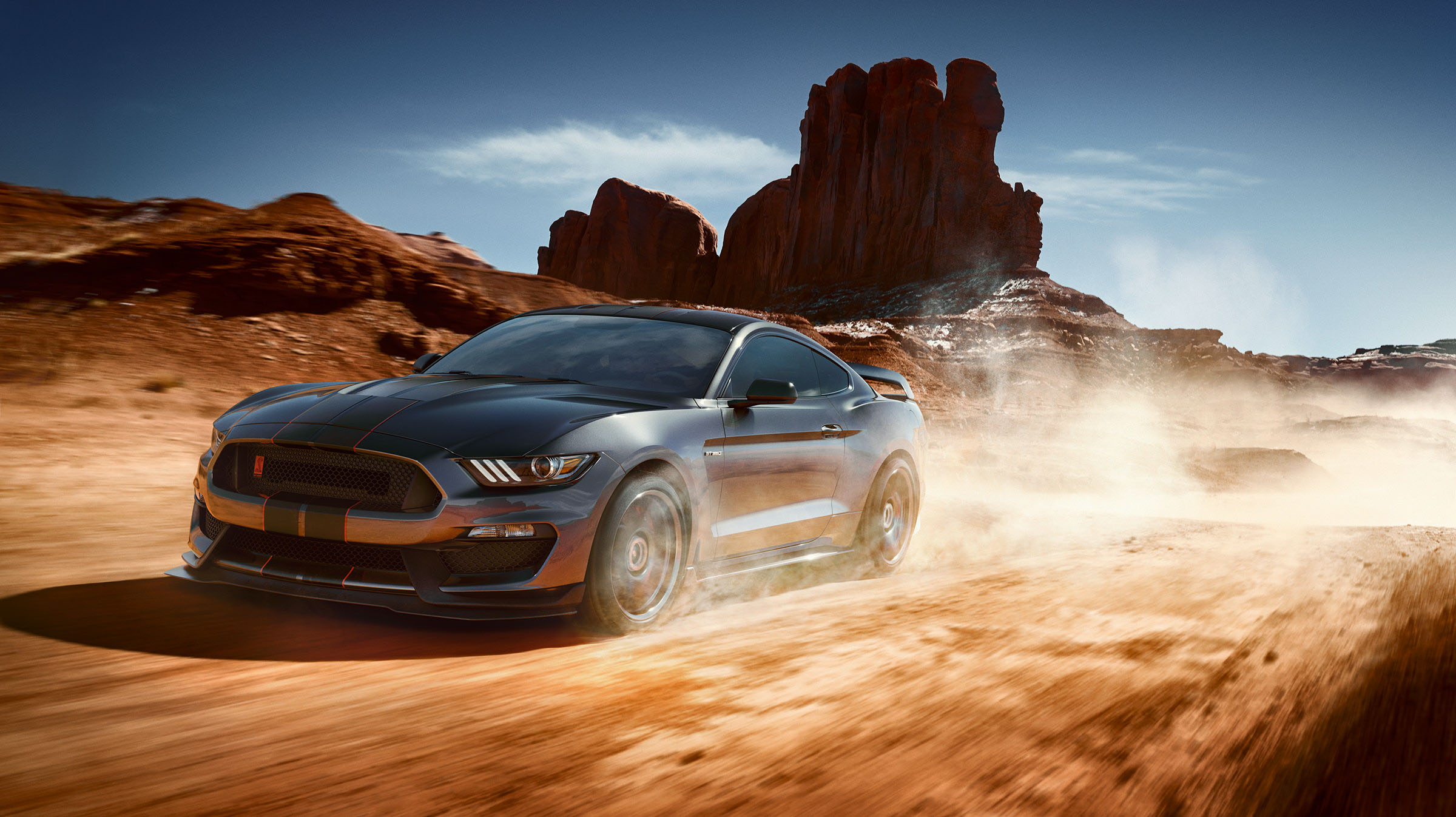 Ford Mustang Shelby driving through desert landscape HD Wallpaper