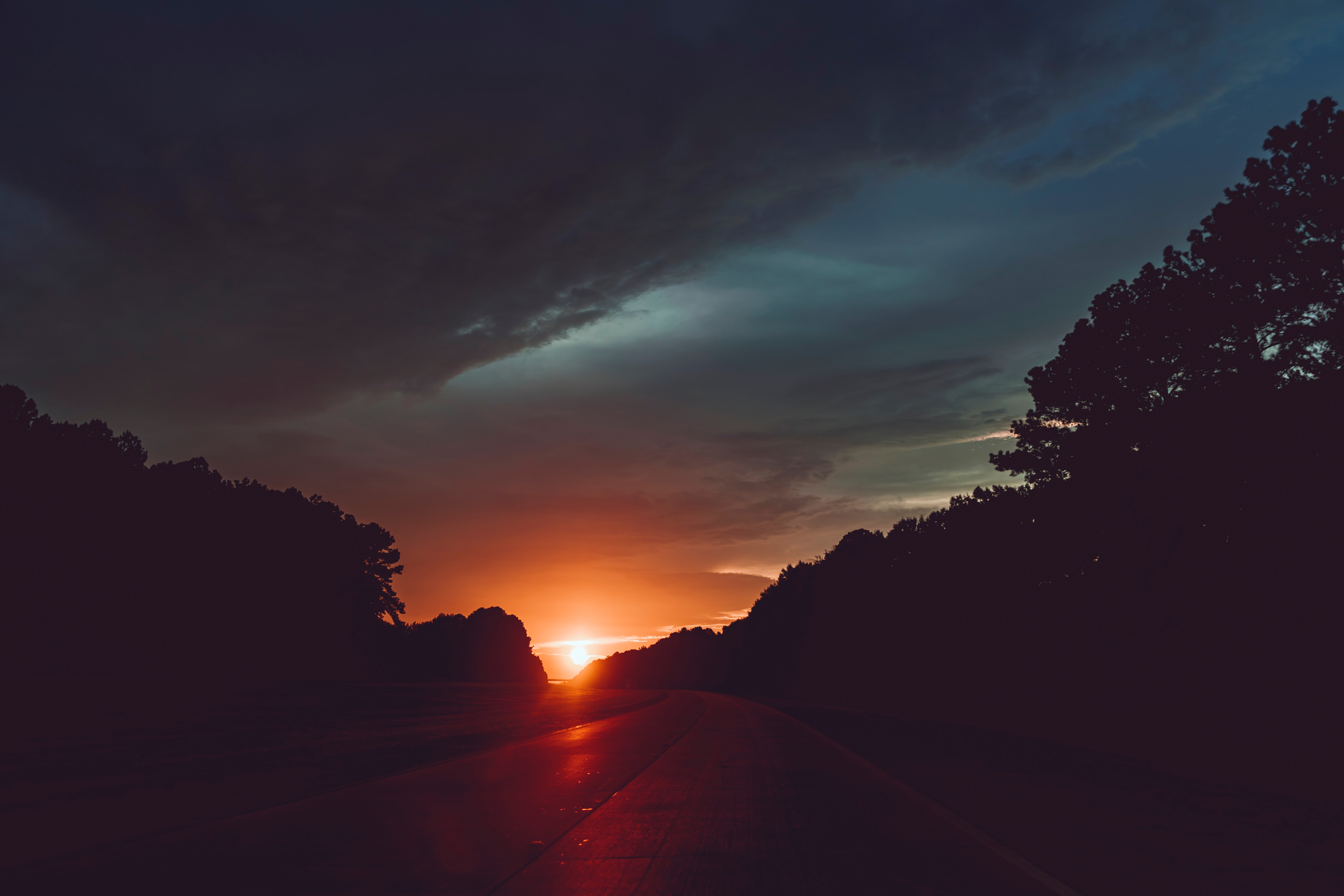 Sunset over a highway with trees HD Wallpaper
