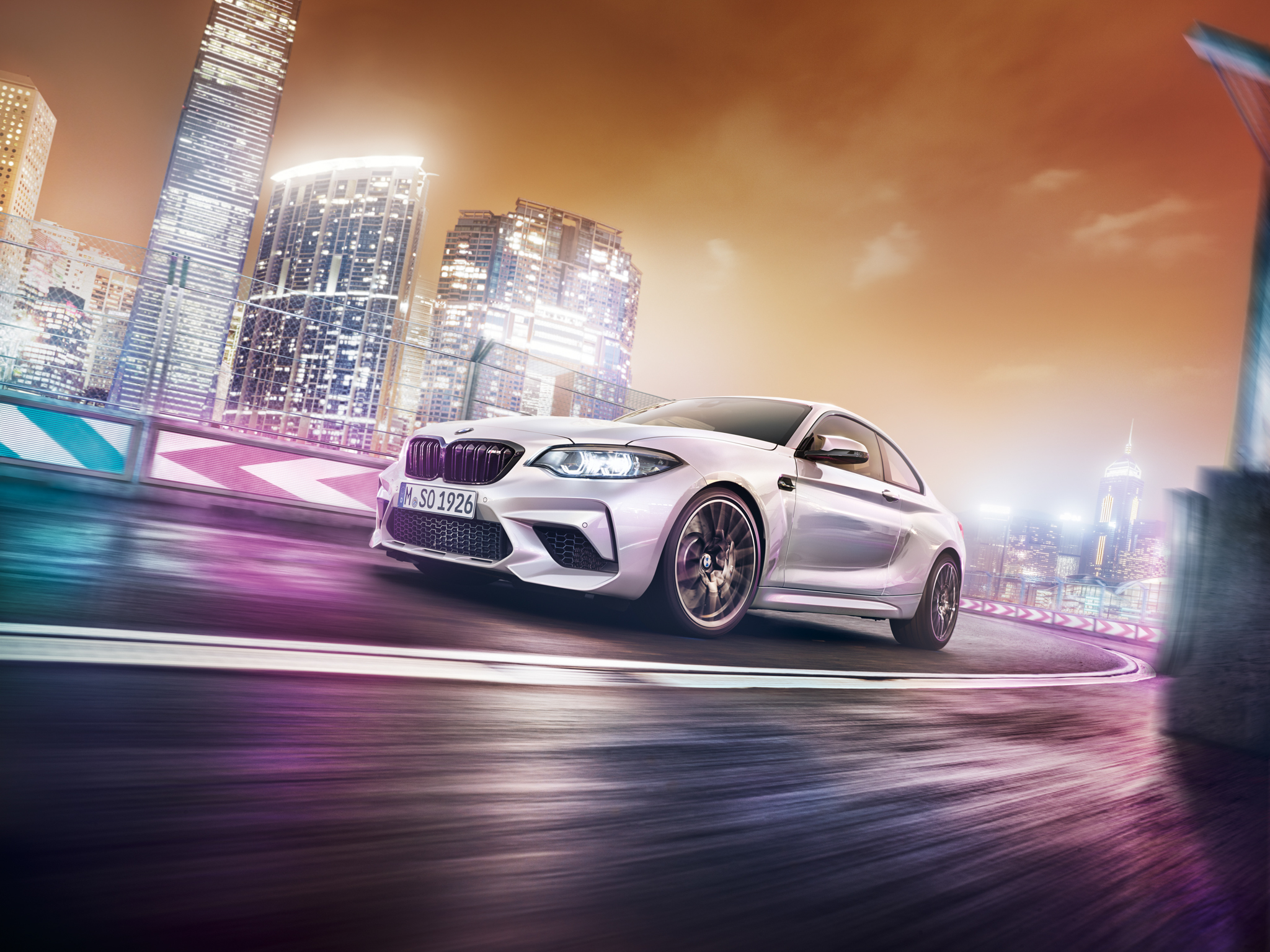 BMW M2 driving through a city at night HD Wallpaper