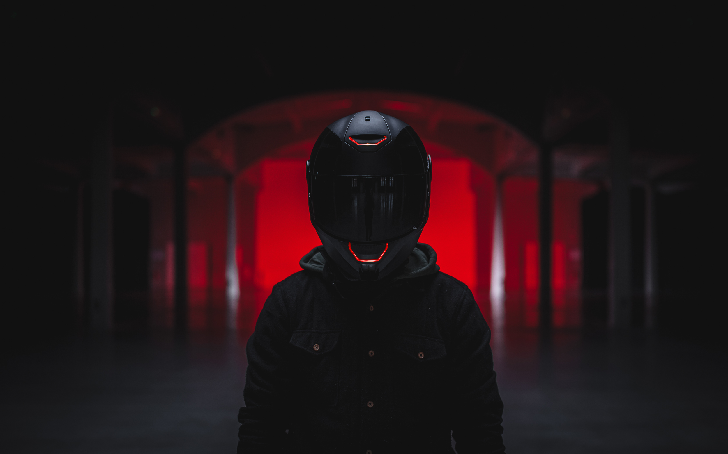 Man in black helmet and jacket with red lights HD Wallpaper