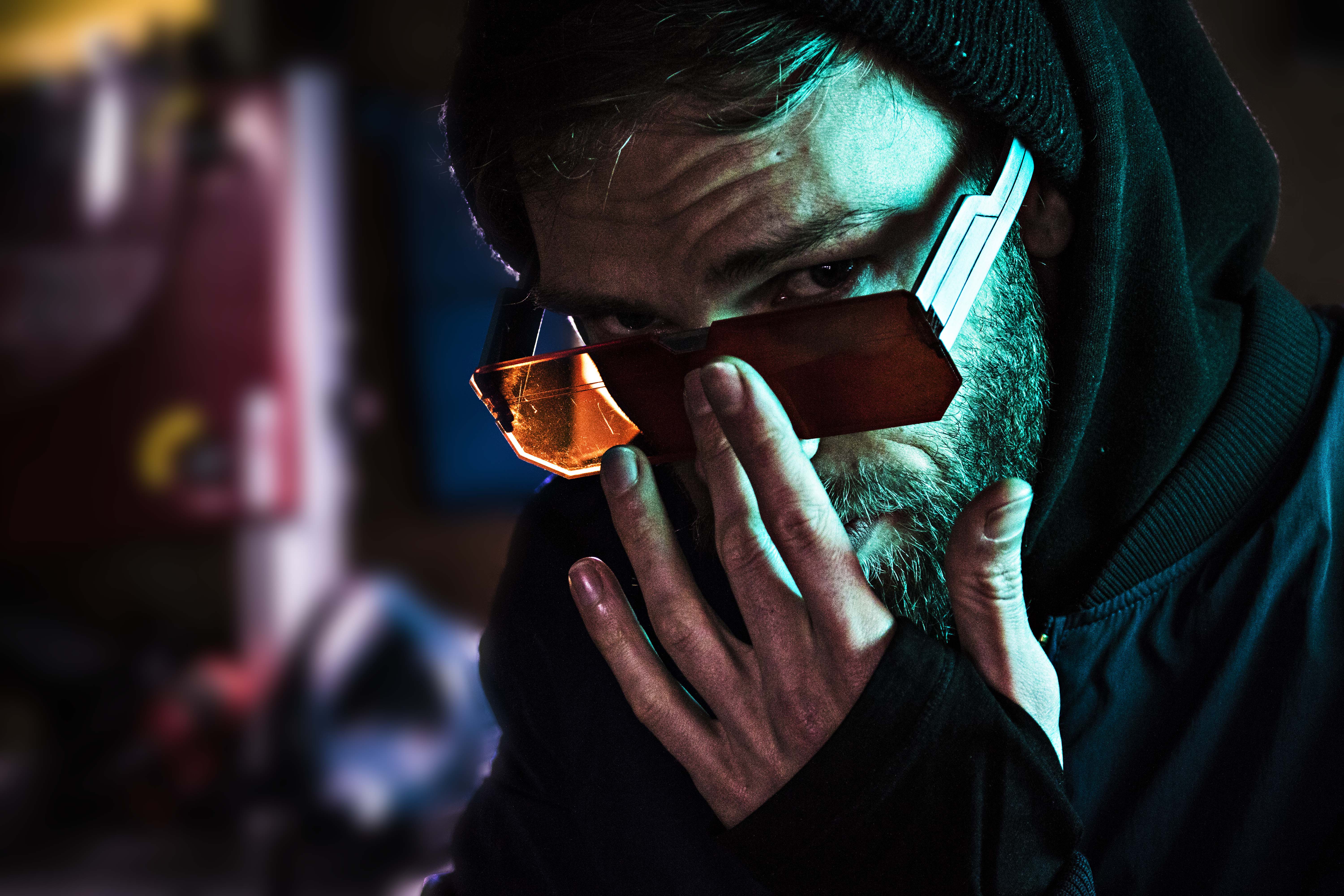 Man wearing futuristic sunglasses and hoodie HD Wallpaper