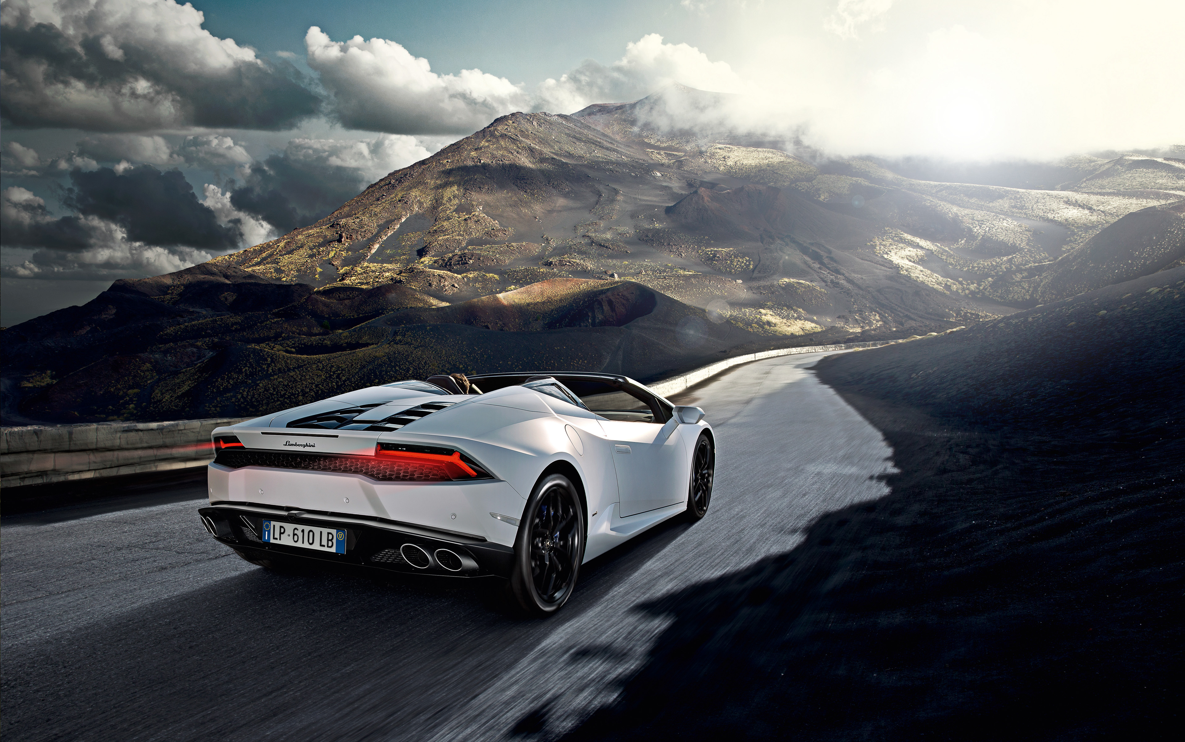 White Lamborghini Huracan driving on a mountain road HD Wallpaper