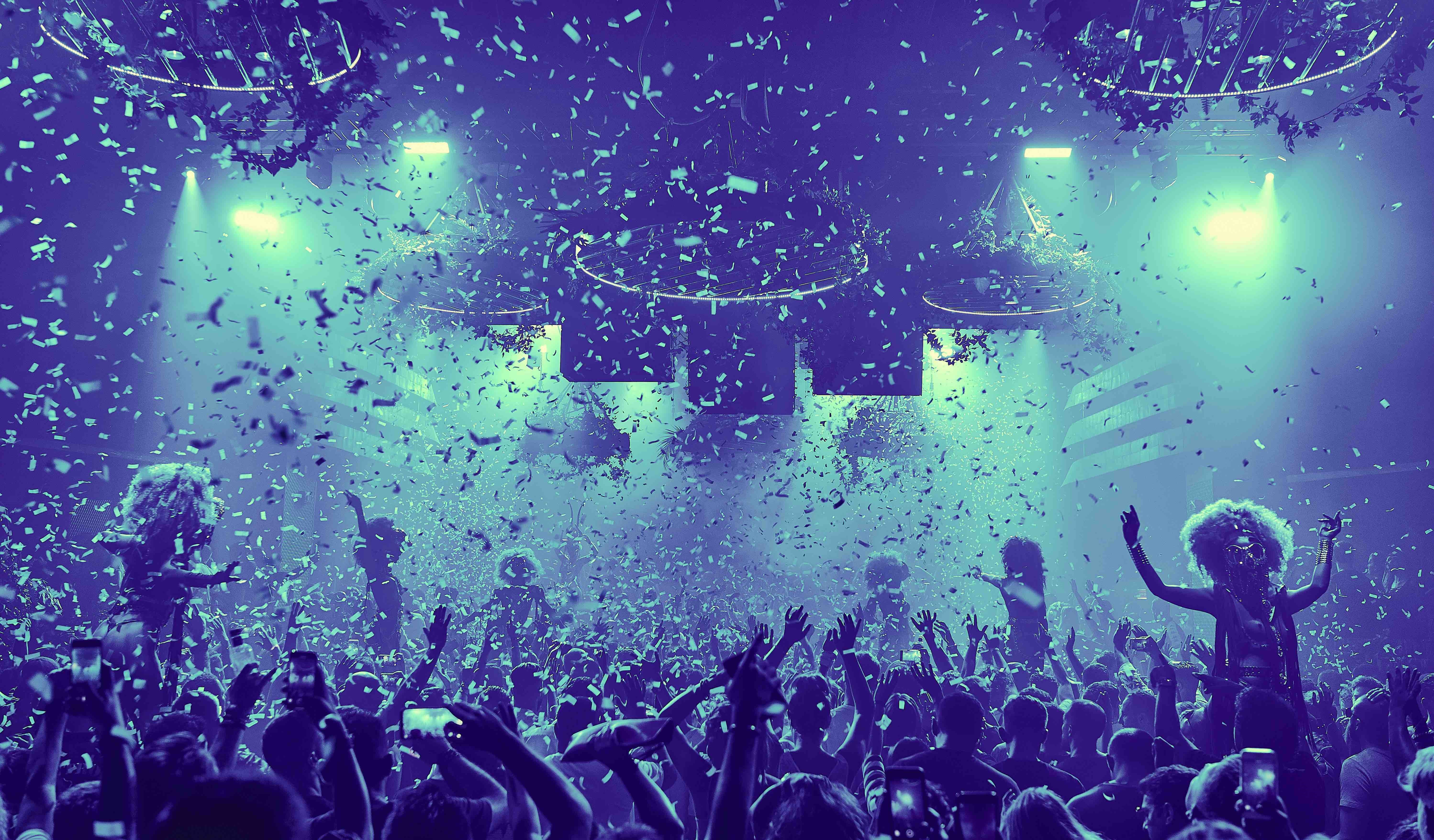 DJ playing music in a club with confetti HD Wallpaper