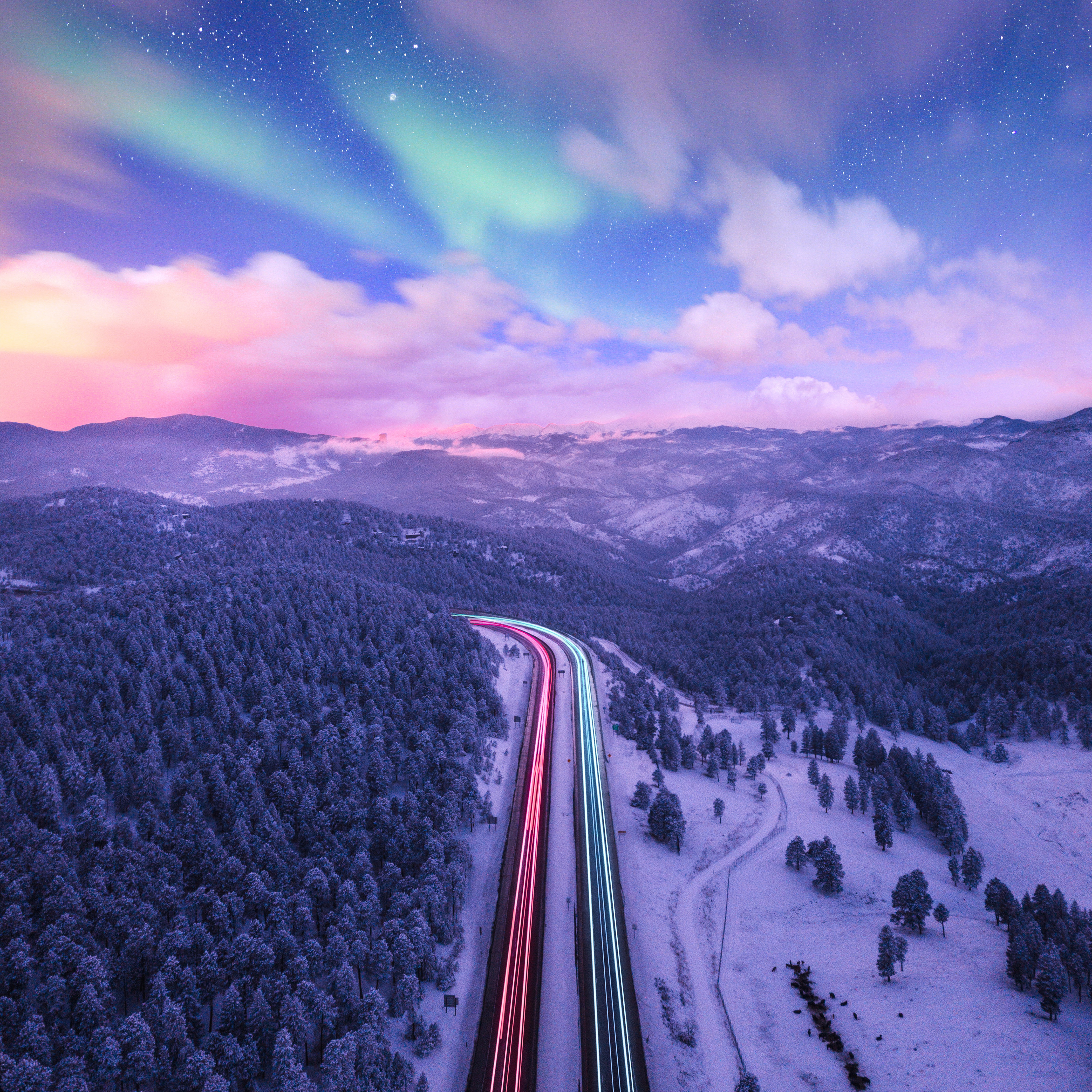 Long exposure road with aurora borealis over snowy mountains HD Wallpaper