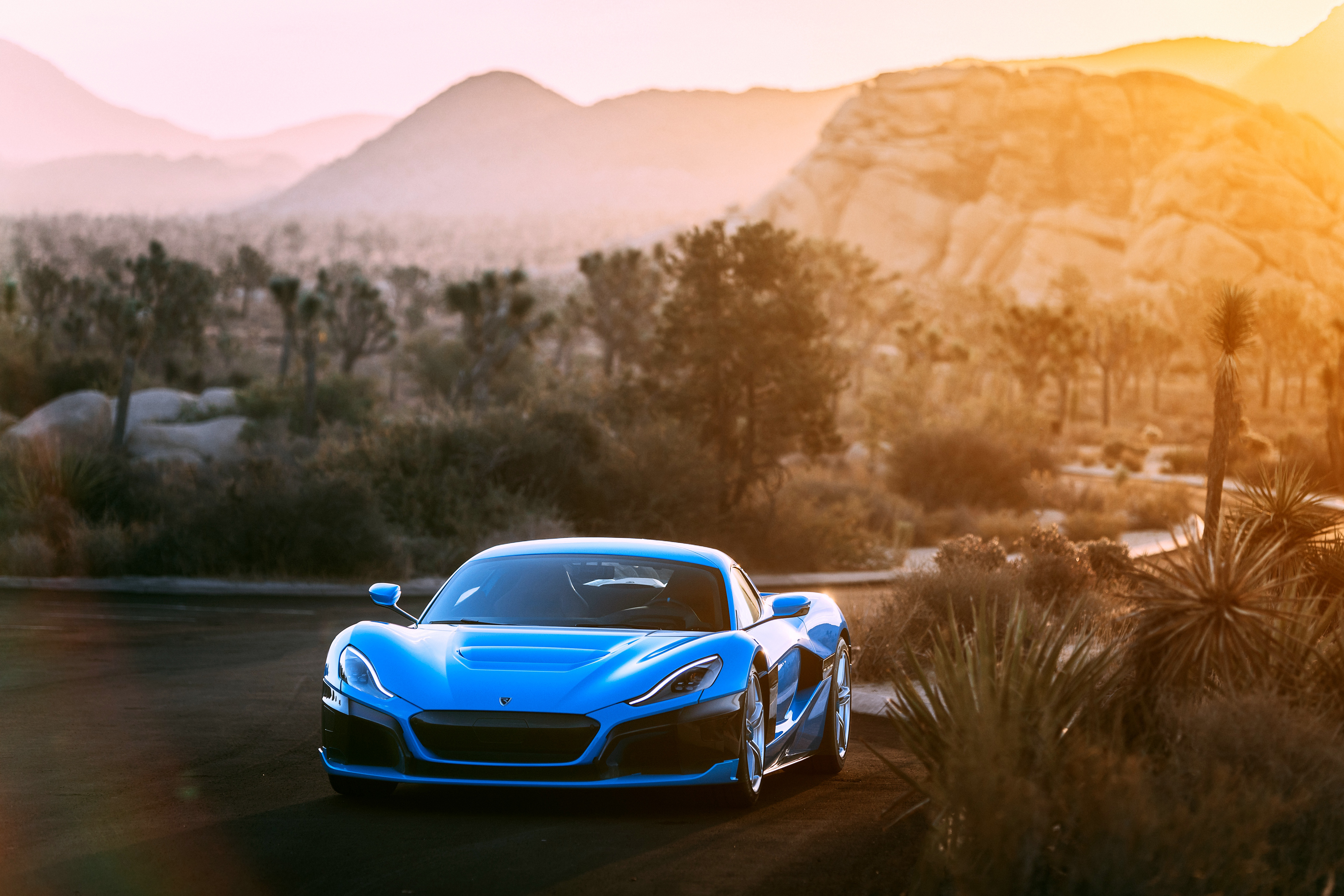 Blue Rimac C Two electric car in desert landscape HD Wallpaper