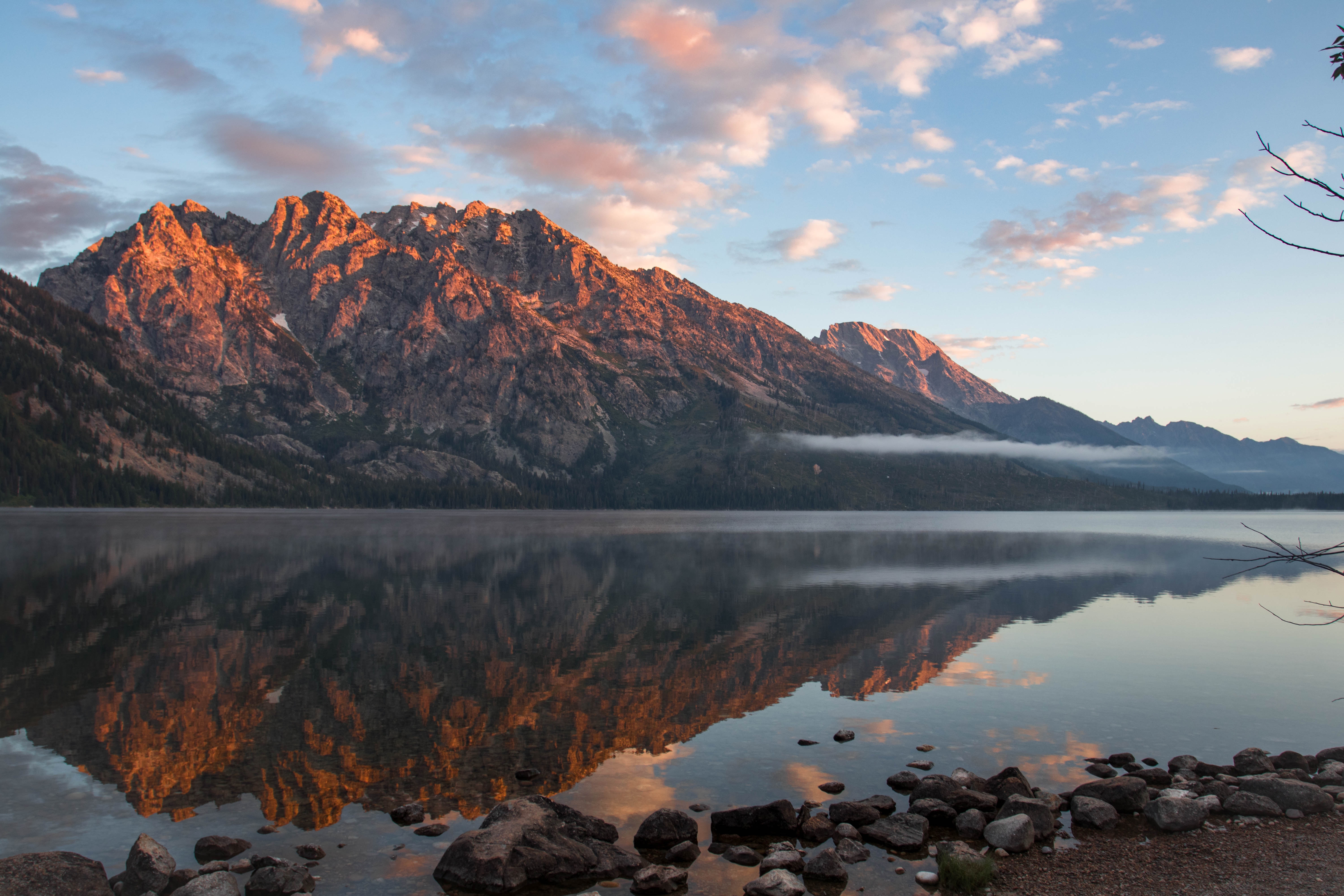 Mountains reflected in a lake at sunrise HD Wallpaper