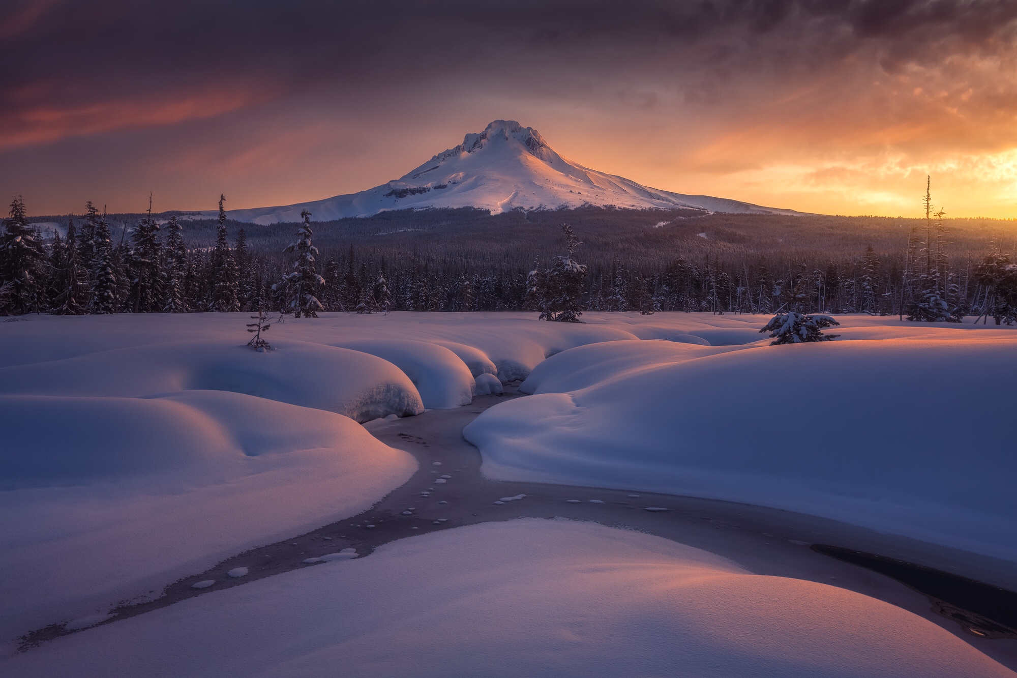 Snowy mountain landscape at sunset with a stream HD Wallpaper