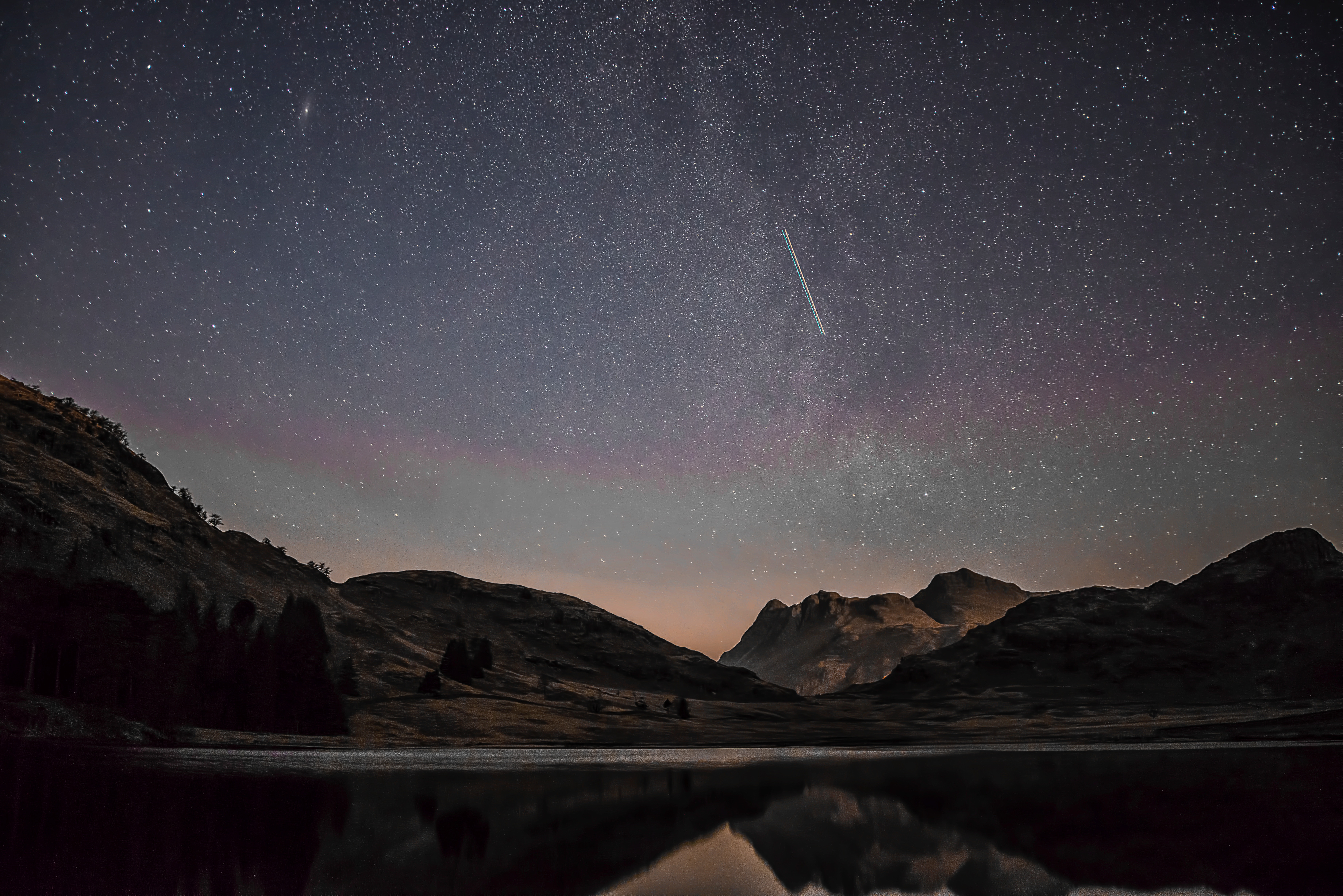 Mountains and shooting star over lake at night HD Wallpaper