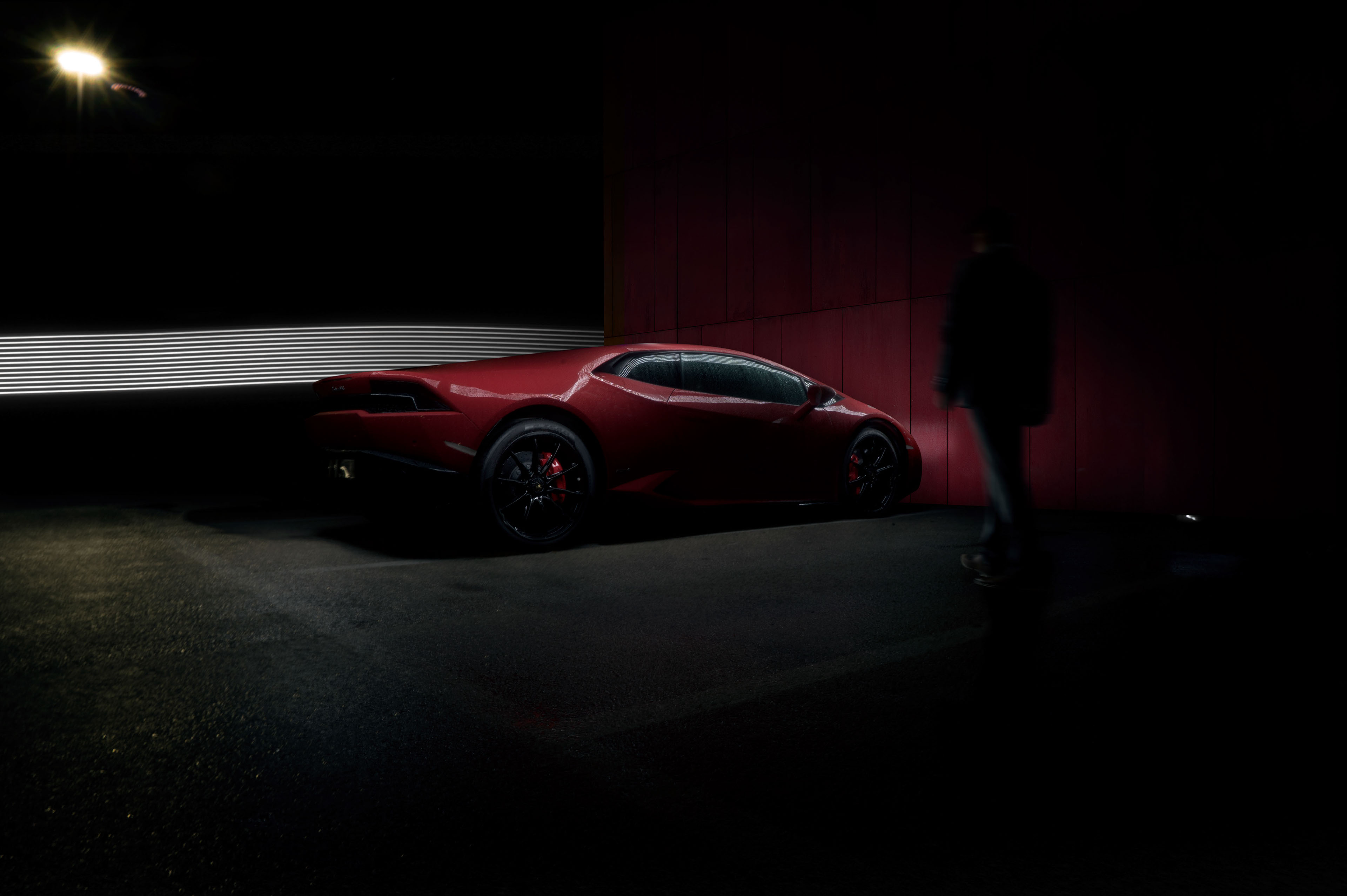 Red Lamborghini Huracan with a person walking HD Wallpaper