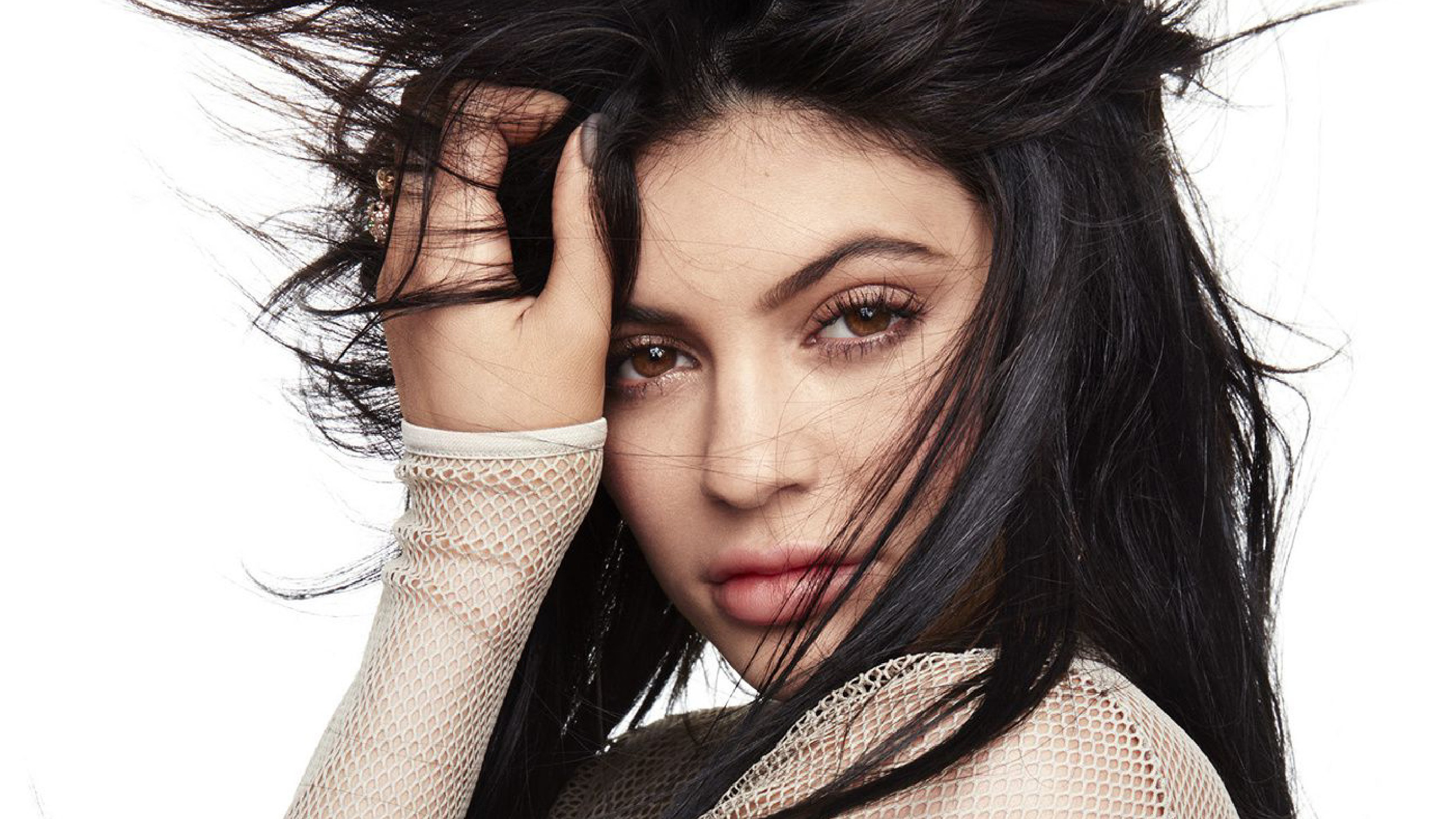 Kylie Jenner posing with her hand in her hair HD Wallpaper