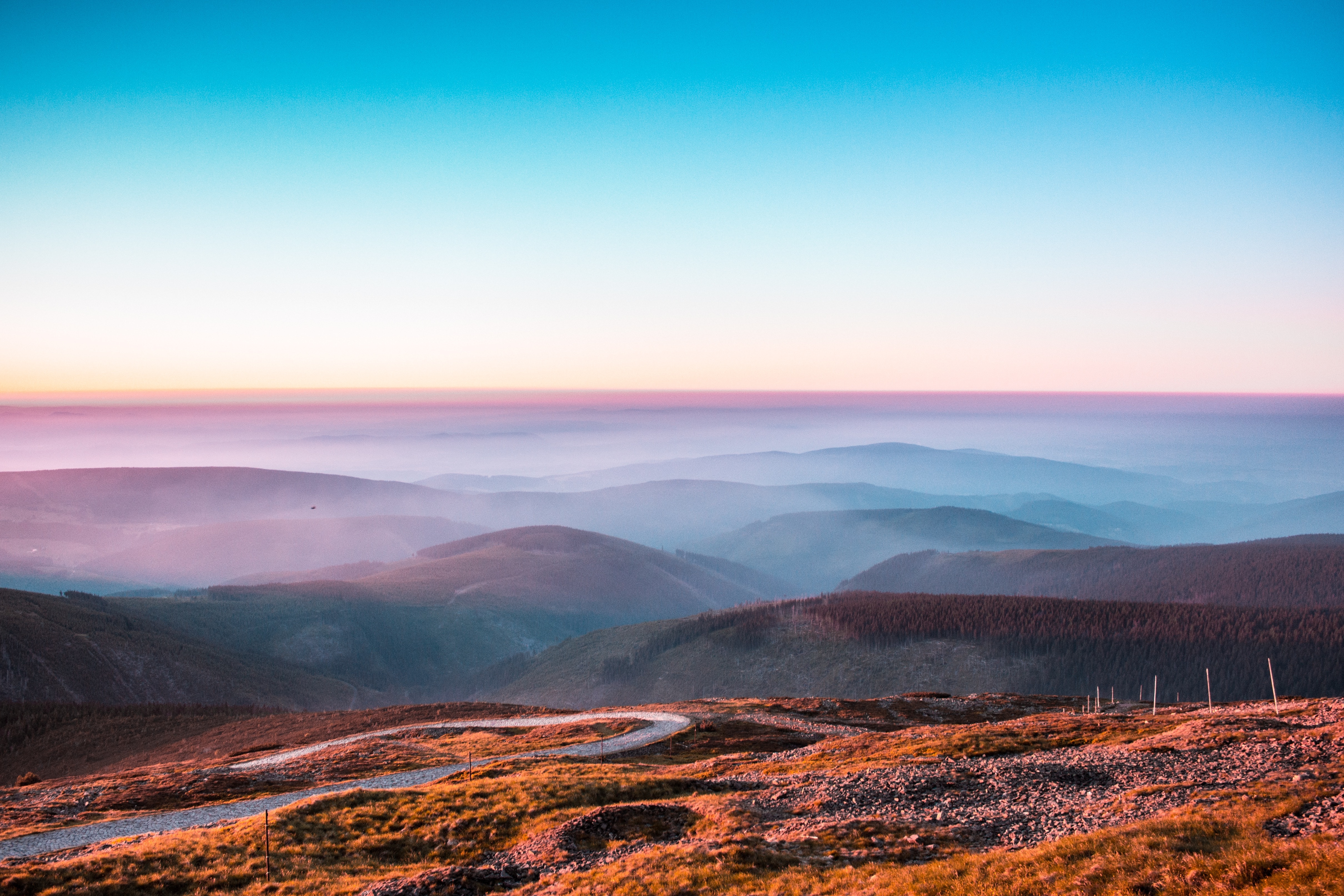 Mountain landscape with a winding road at sunrise 4K HD Wallpaper