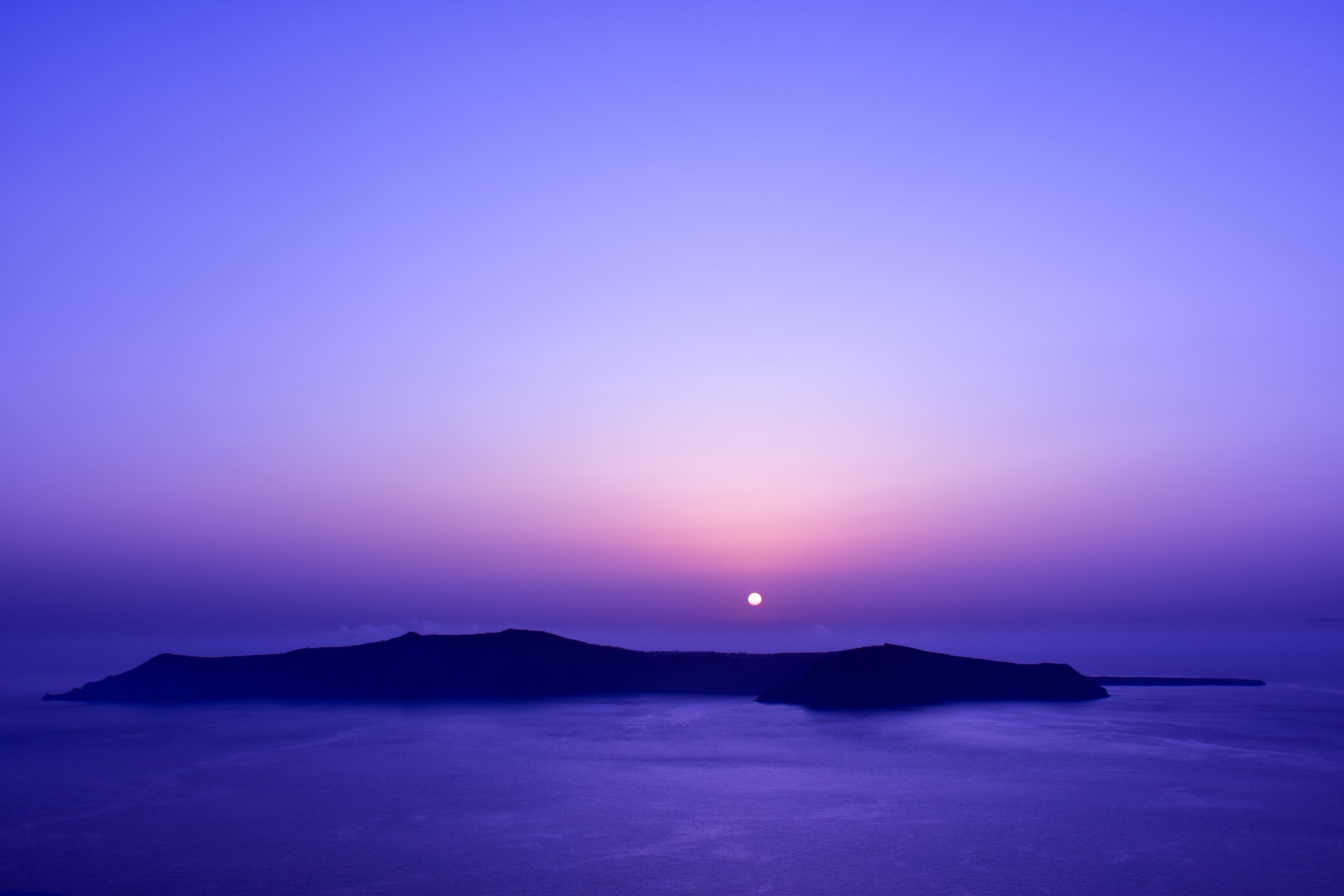Sunset over the ocean with islands HD Wallpaper
