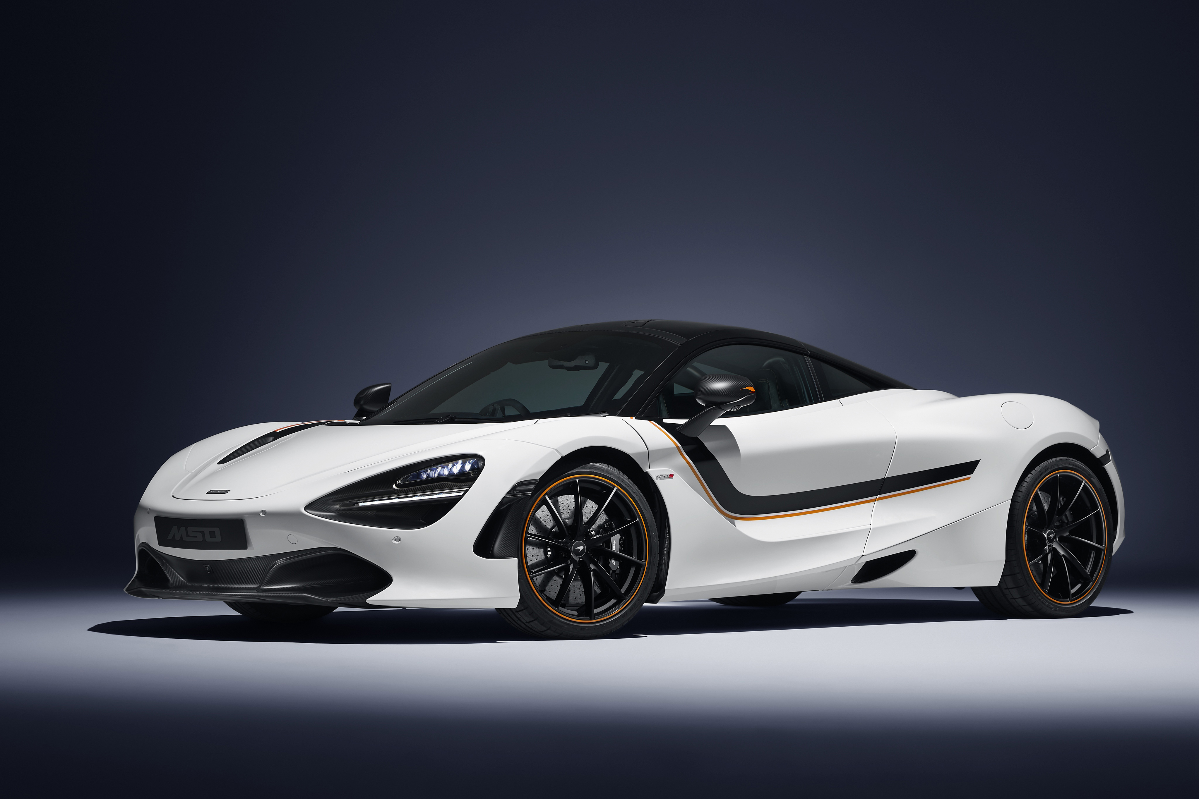 White McLaren 720S with orange and black accents HD Wallpaper