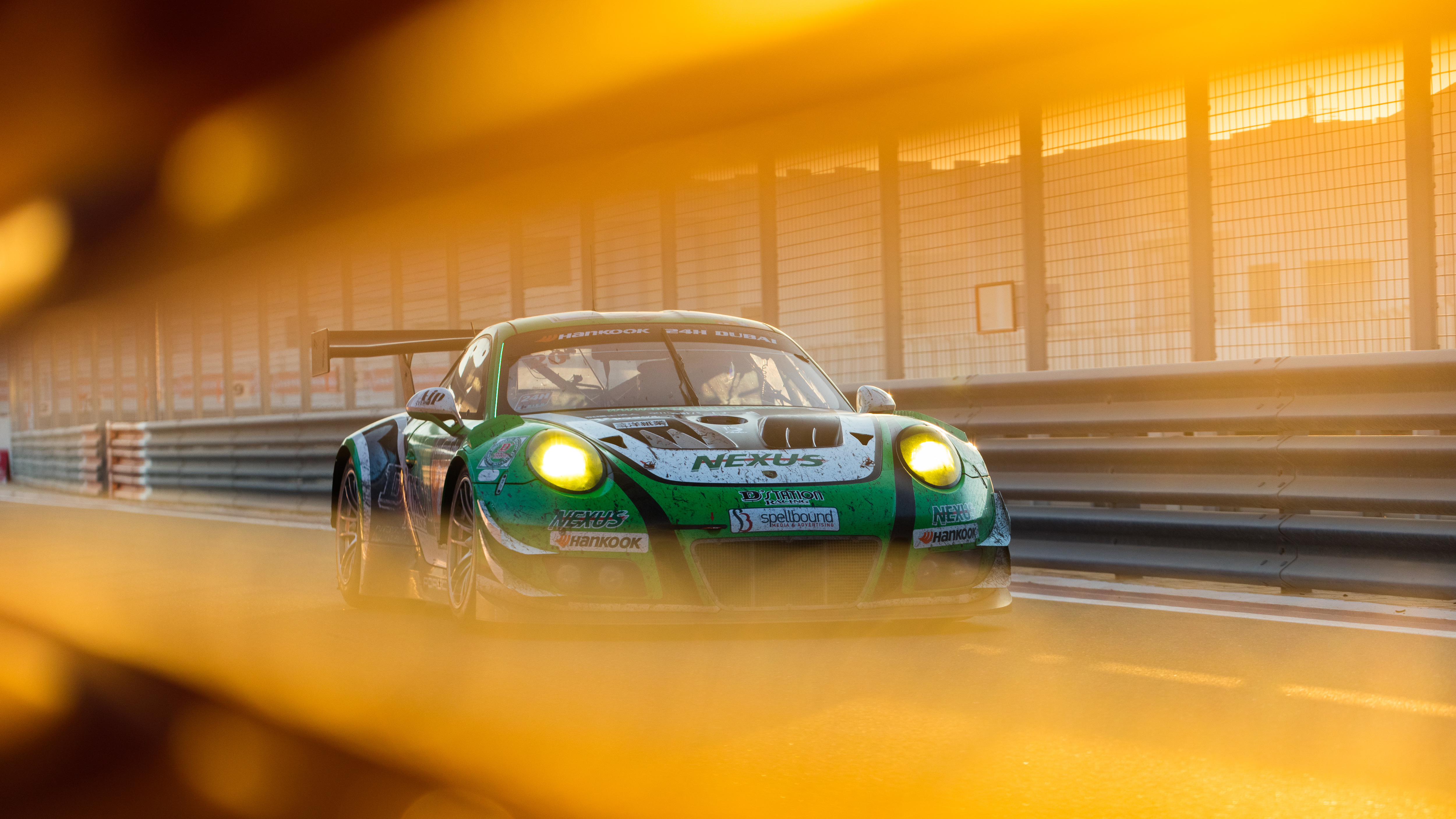 Green Porsche 911 GT3 R race car on track HD Wallpaper