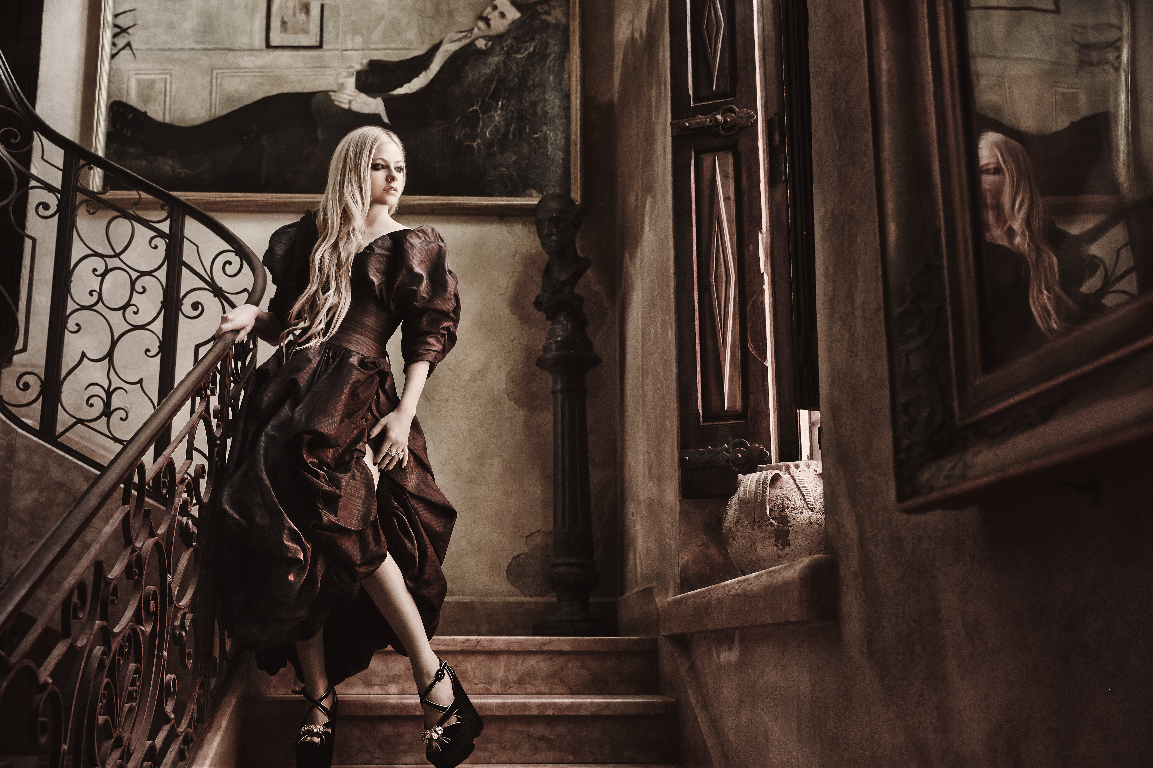 Avril Lavigne posing on a grand staircase HD Wallpaper