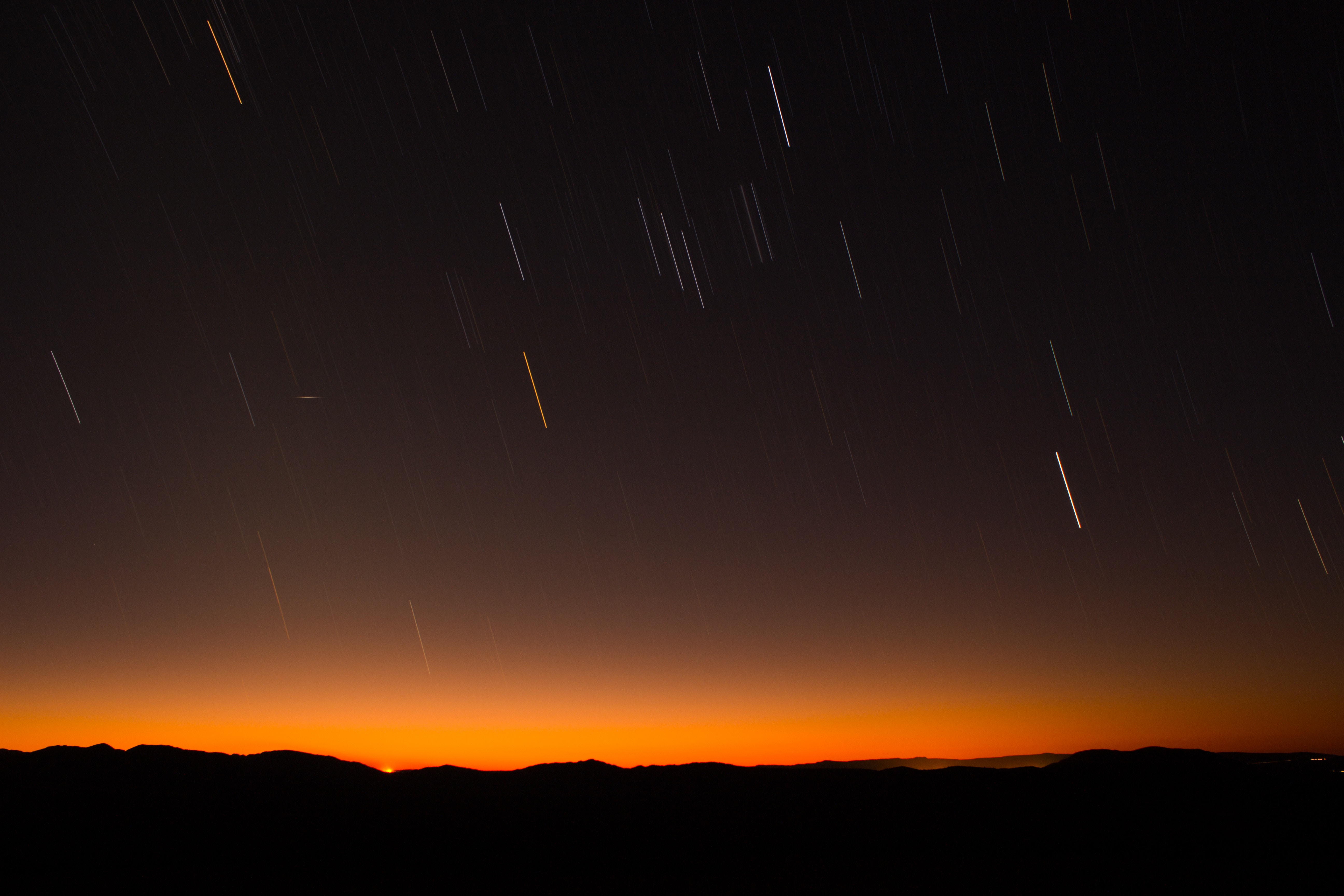 Star trails over mountains at sunset HD Wallpaper