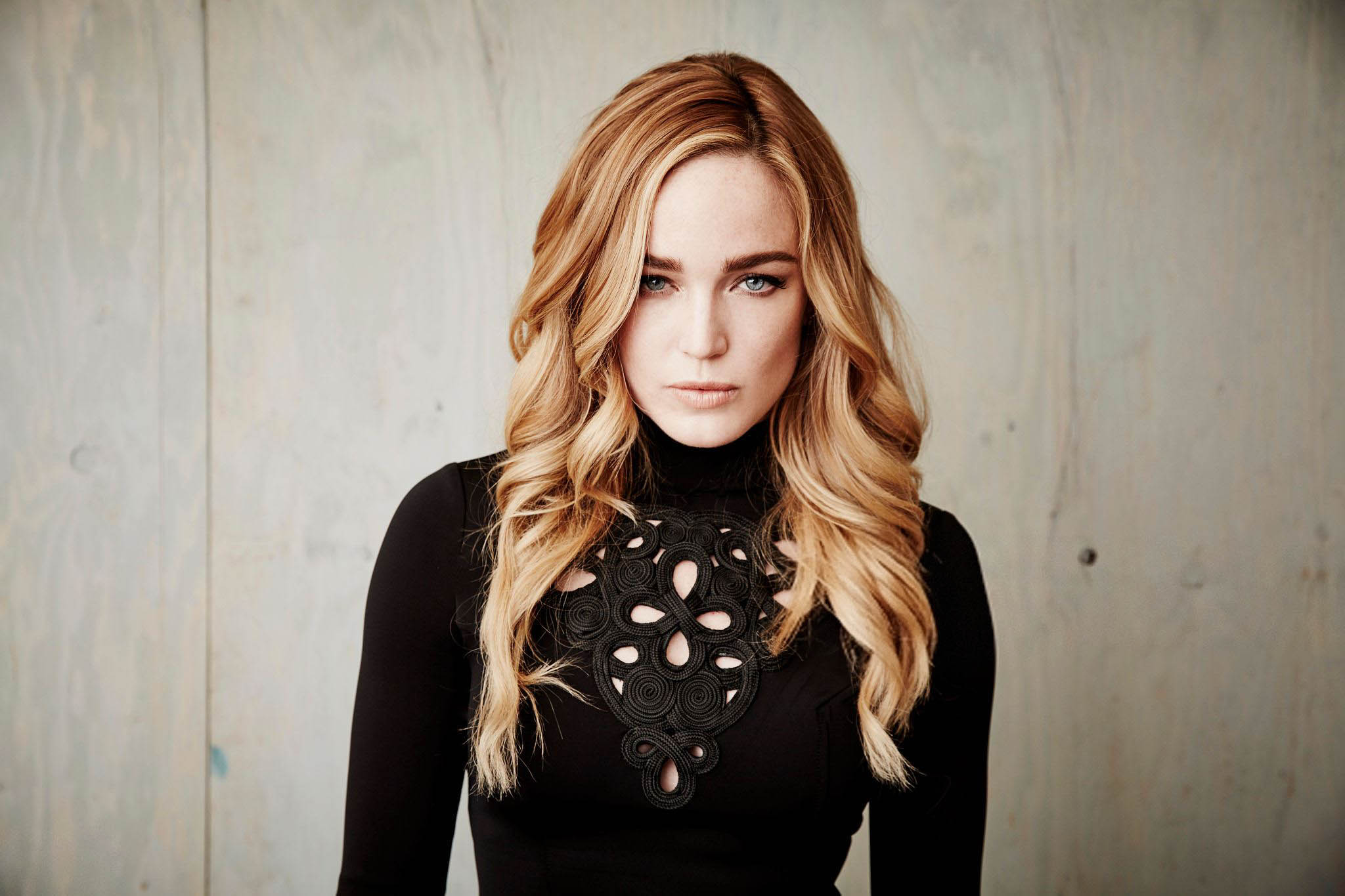Caity Lotz in a black turtleneck HD Wallpaper