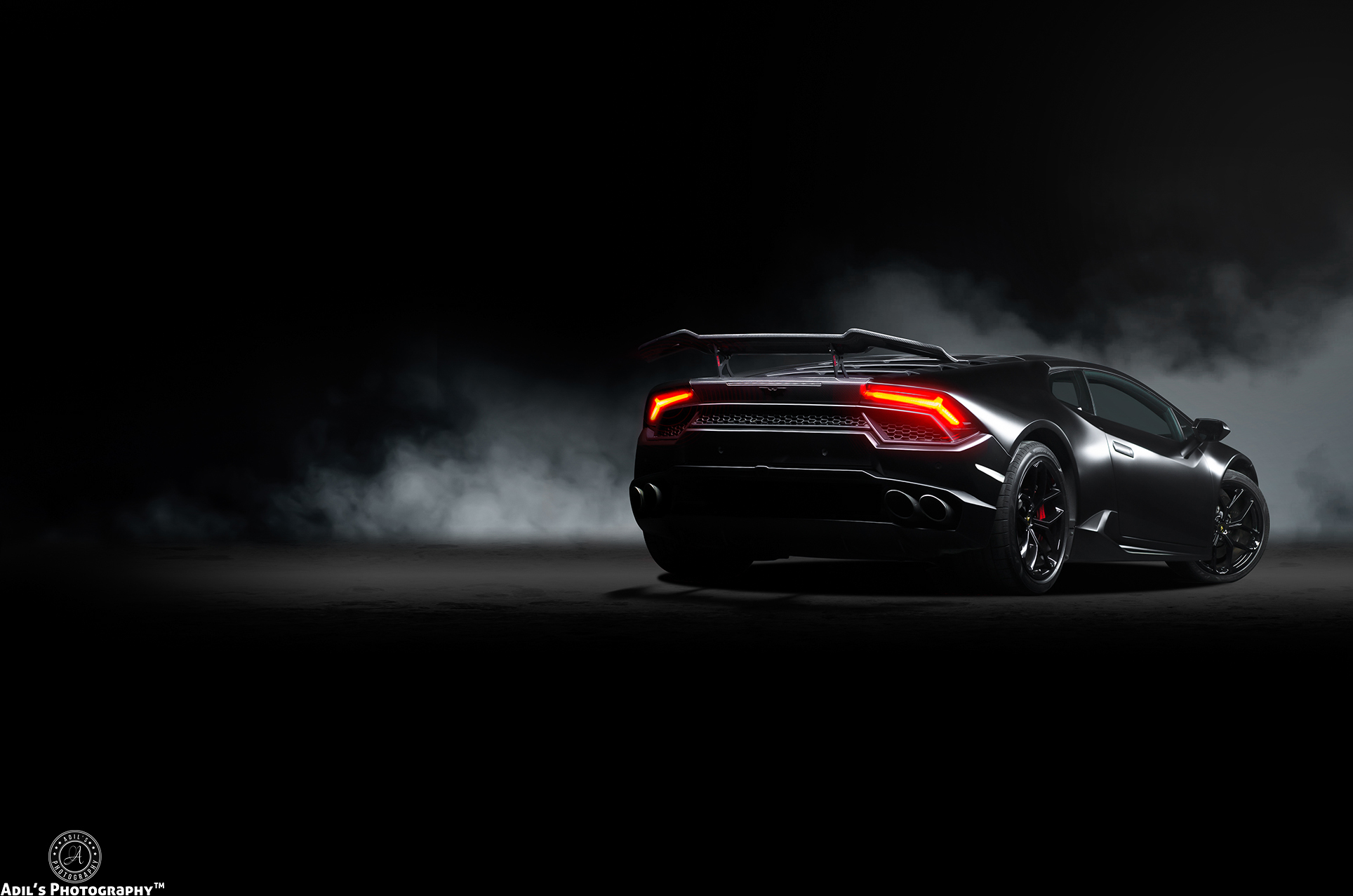 Black Lamborghini Huracan with red taillights in smoke HD Wallpaper
