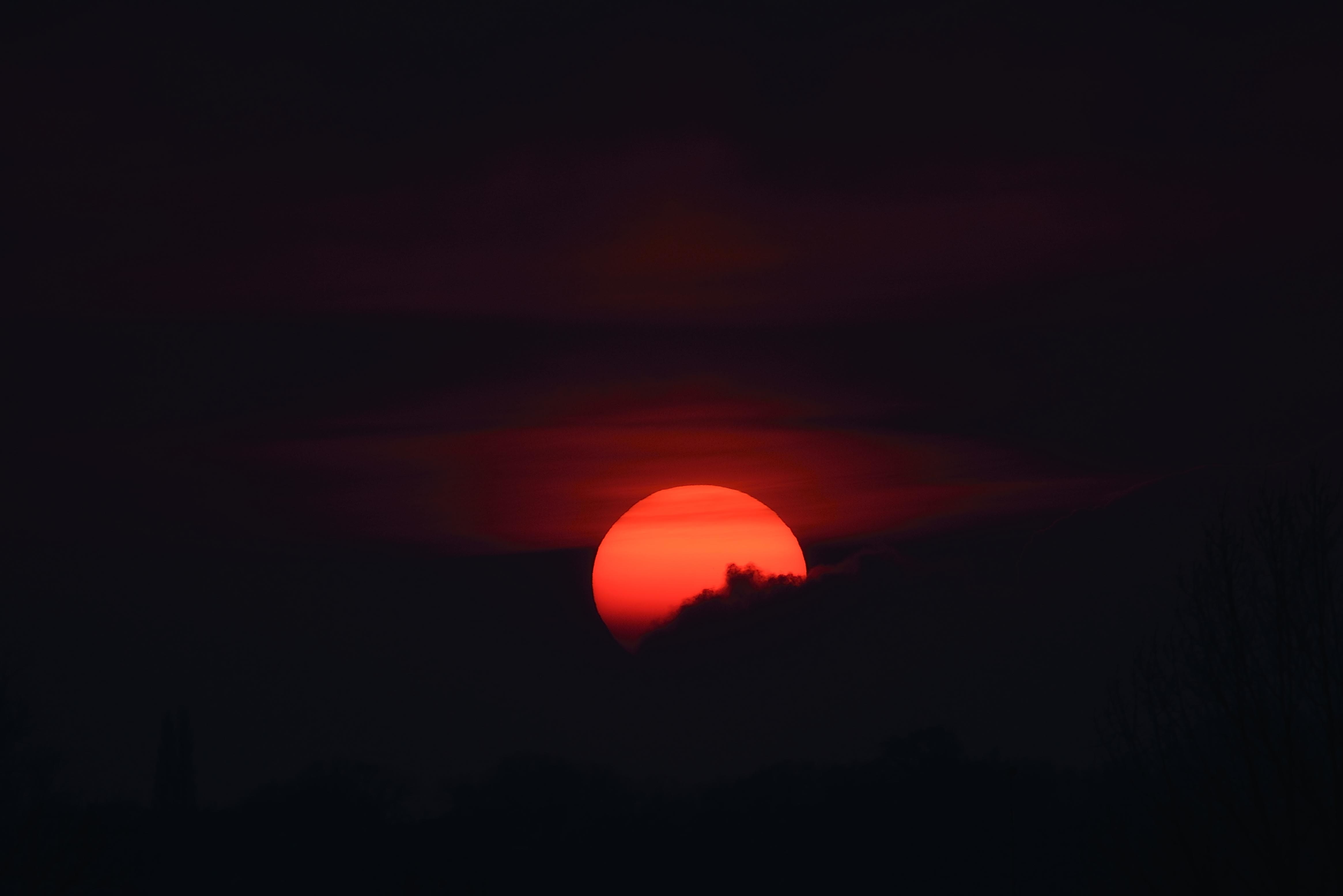 Sunset behind dark clouds HD Wallpaper