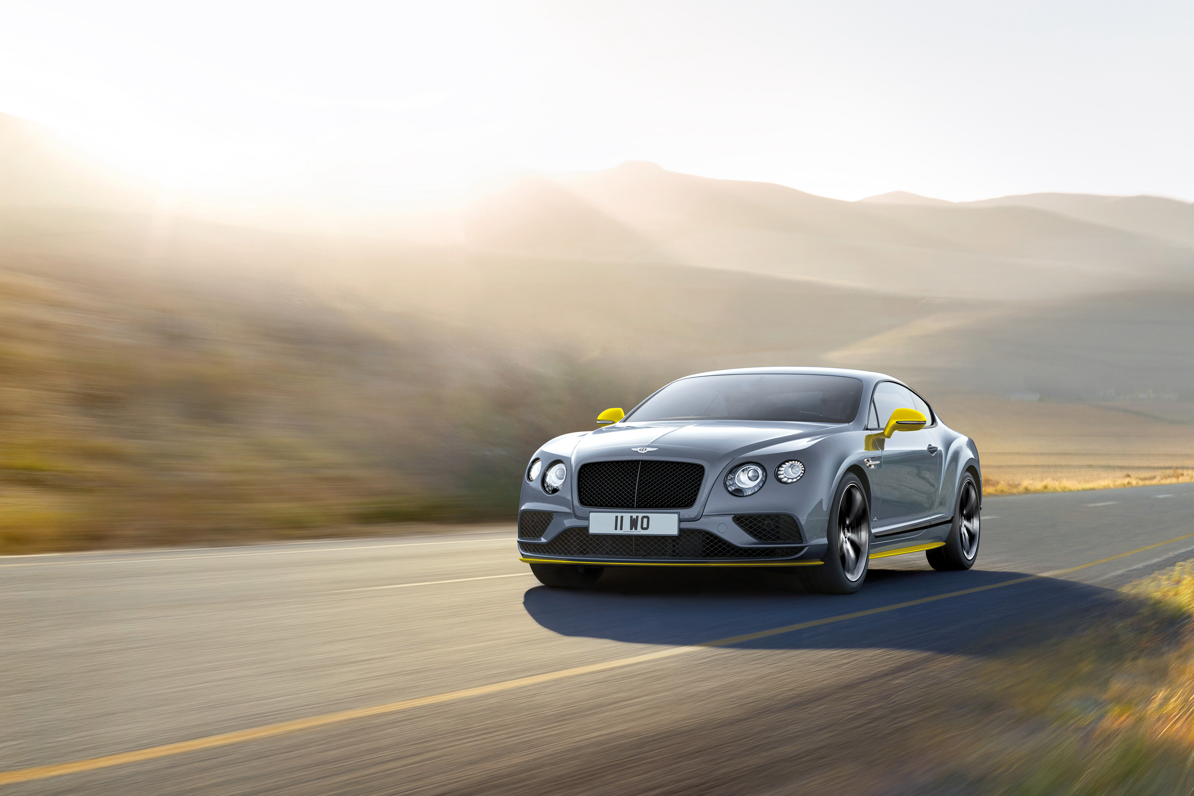 Bentley Continental GT driving on a road HD Wallpaper