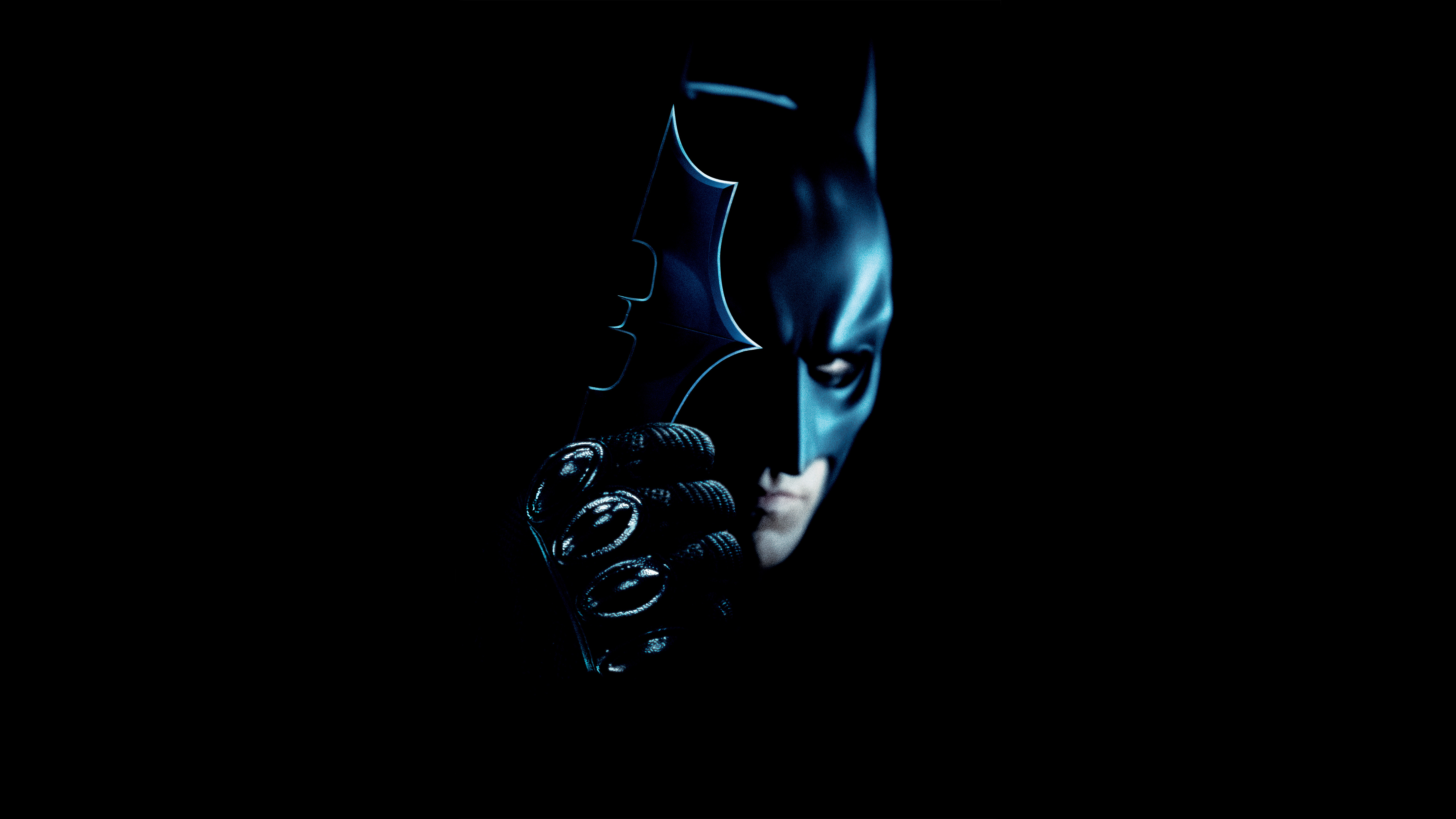 Batman holding a Batarang in the dark HD Wallpaper