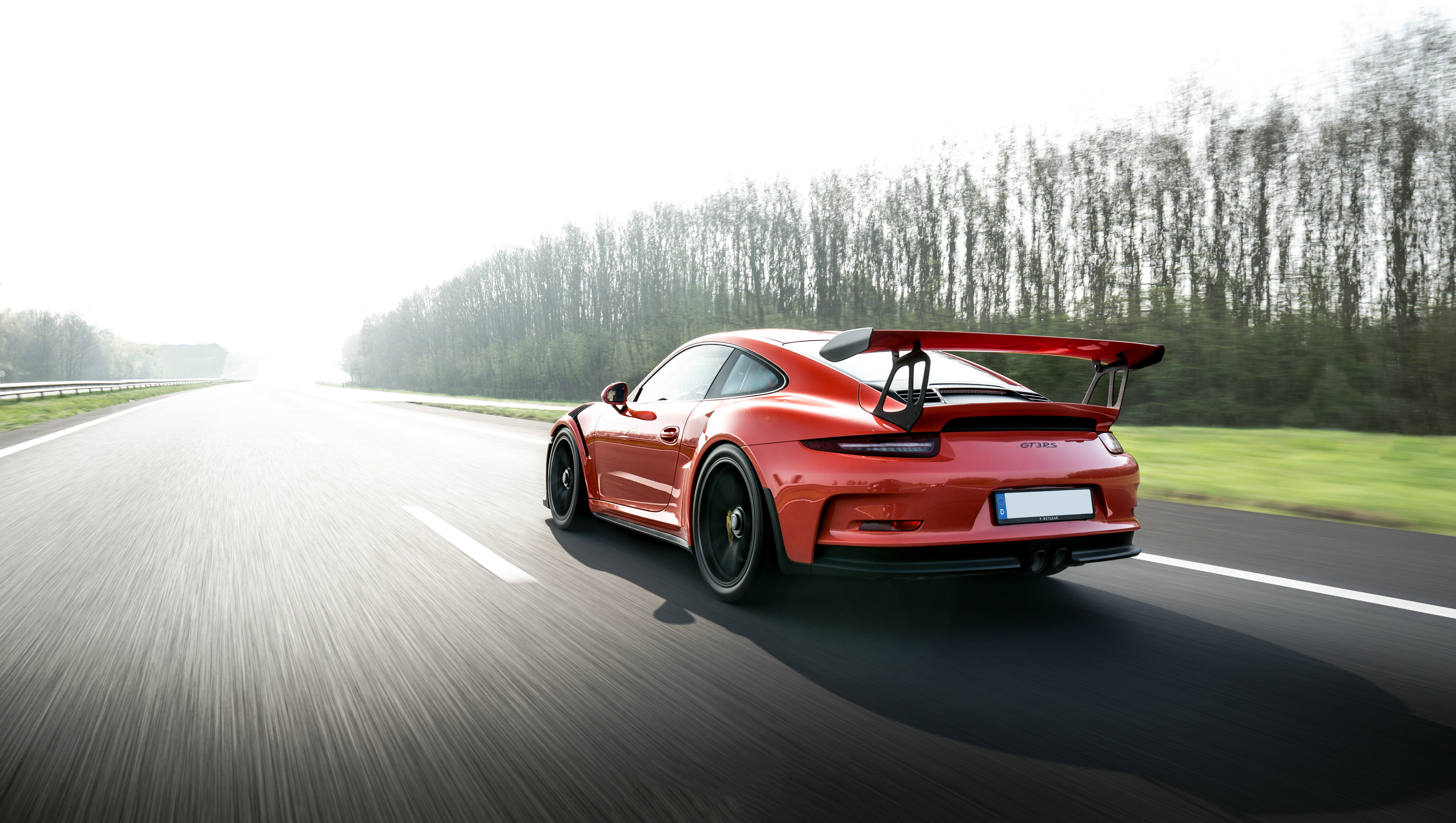 Red Porsche 911 GT3 R driving on a highway HD Wallpaper