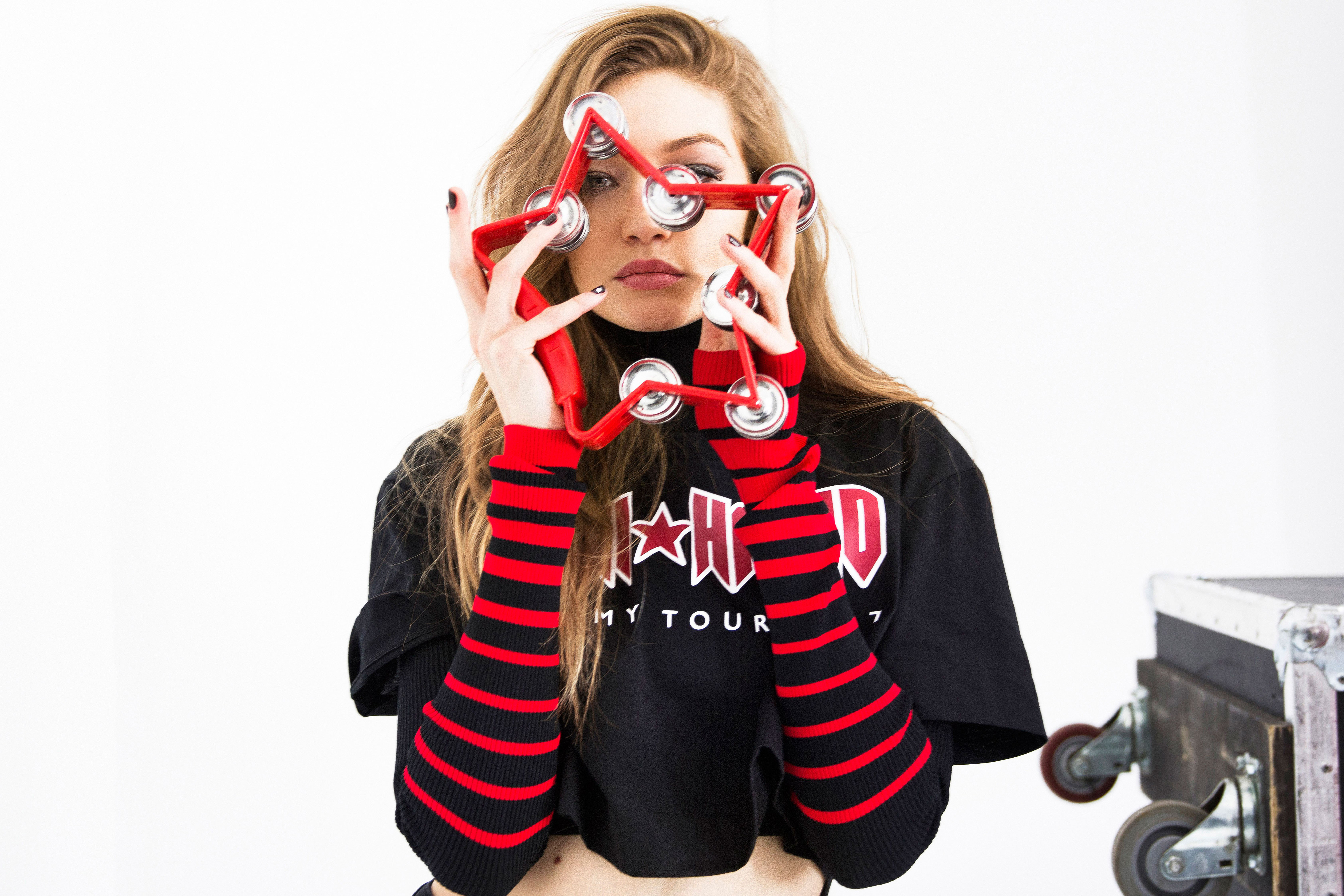 Gigi Hadid holding a star-shaped tambourine HD Wallpaper