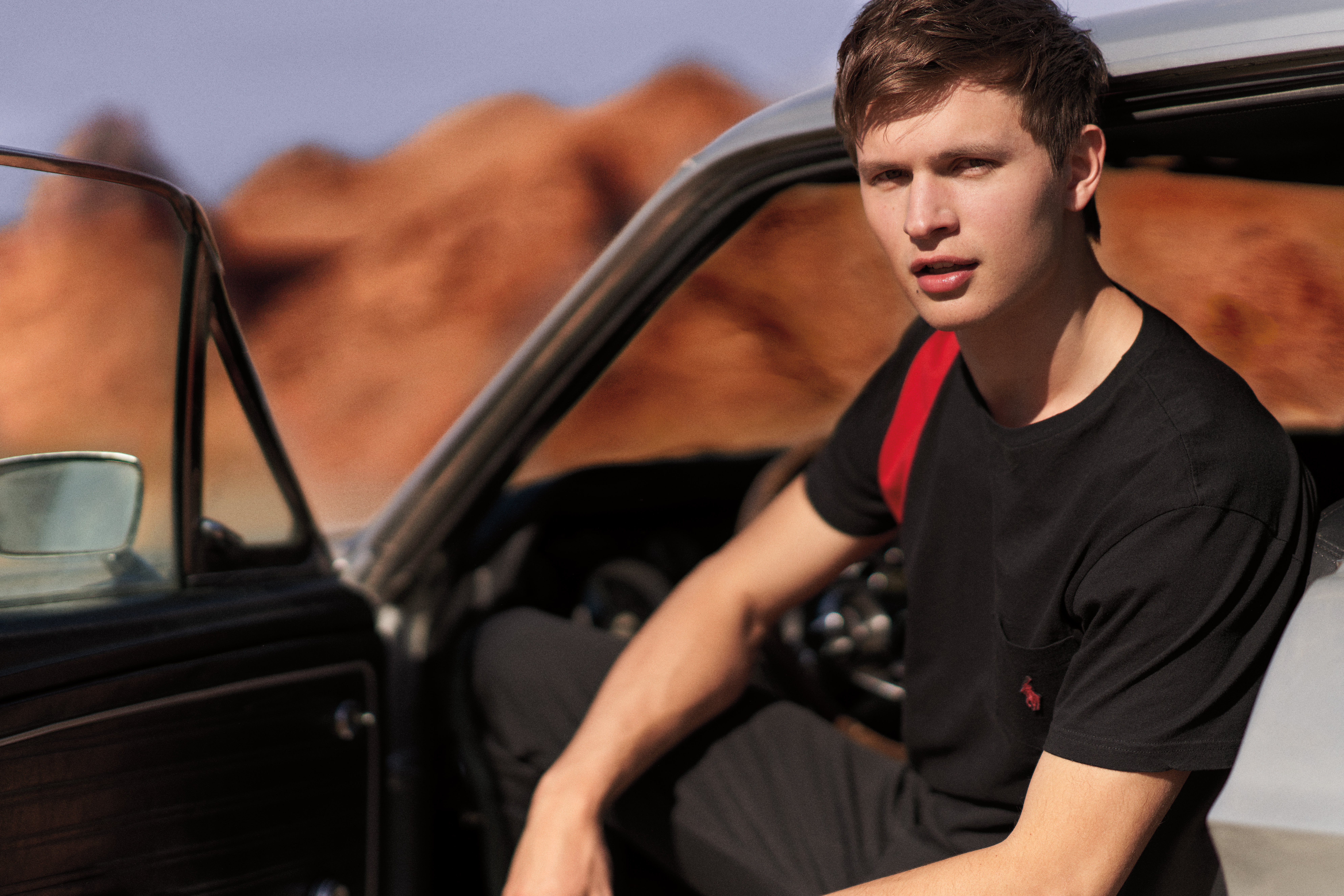 Ansel Elgort in a car in the desert HD Wallpaper