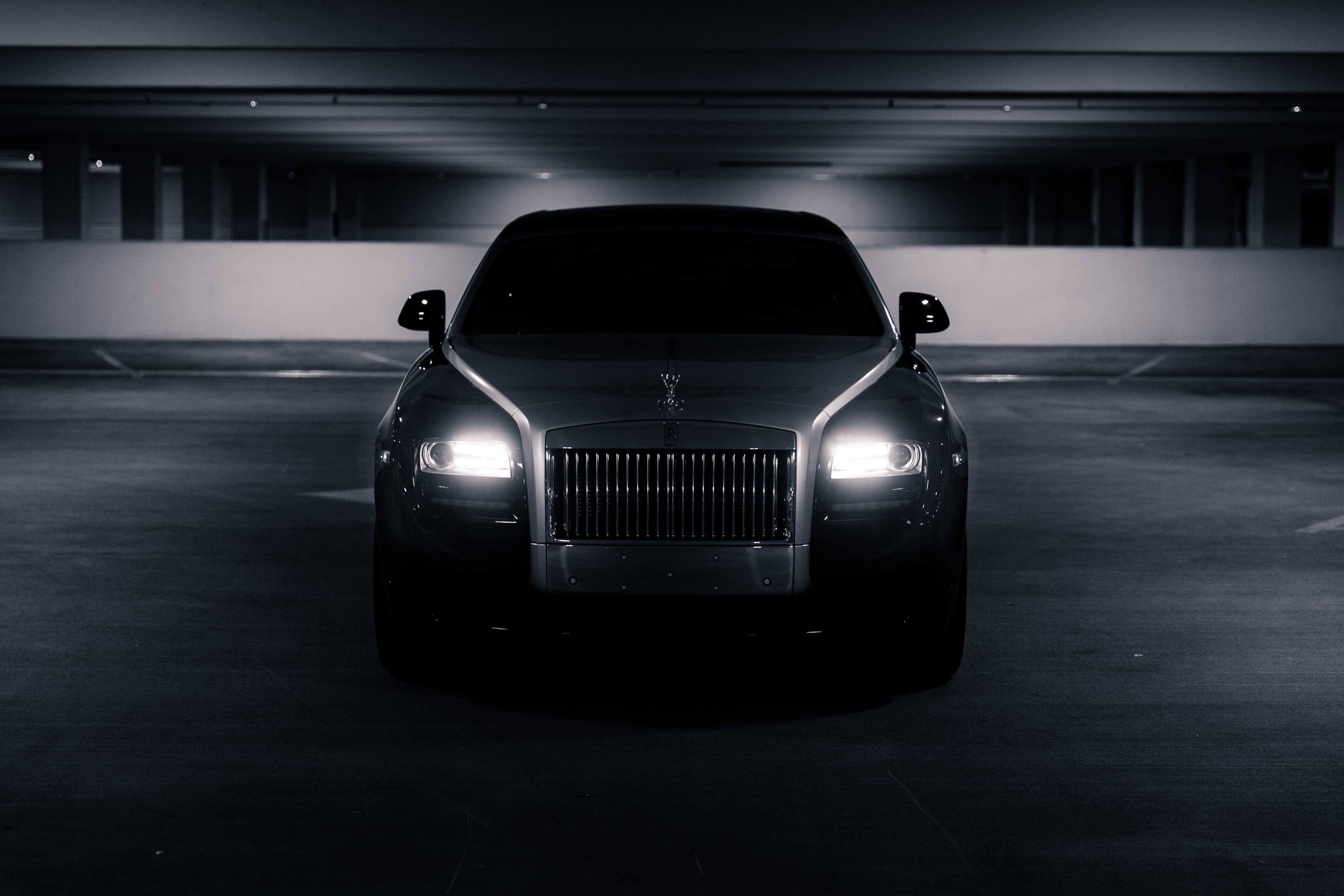 Rolls-Royce car with headlights on in a parking garage HD Wallpaper