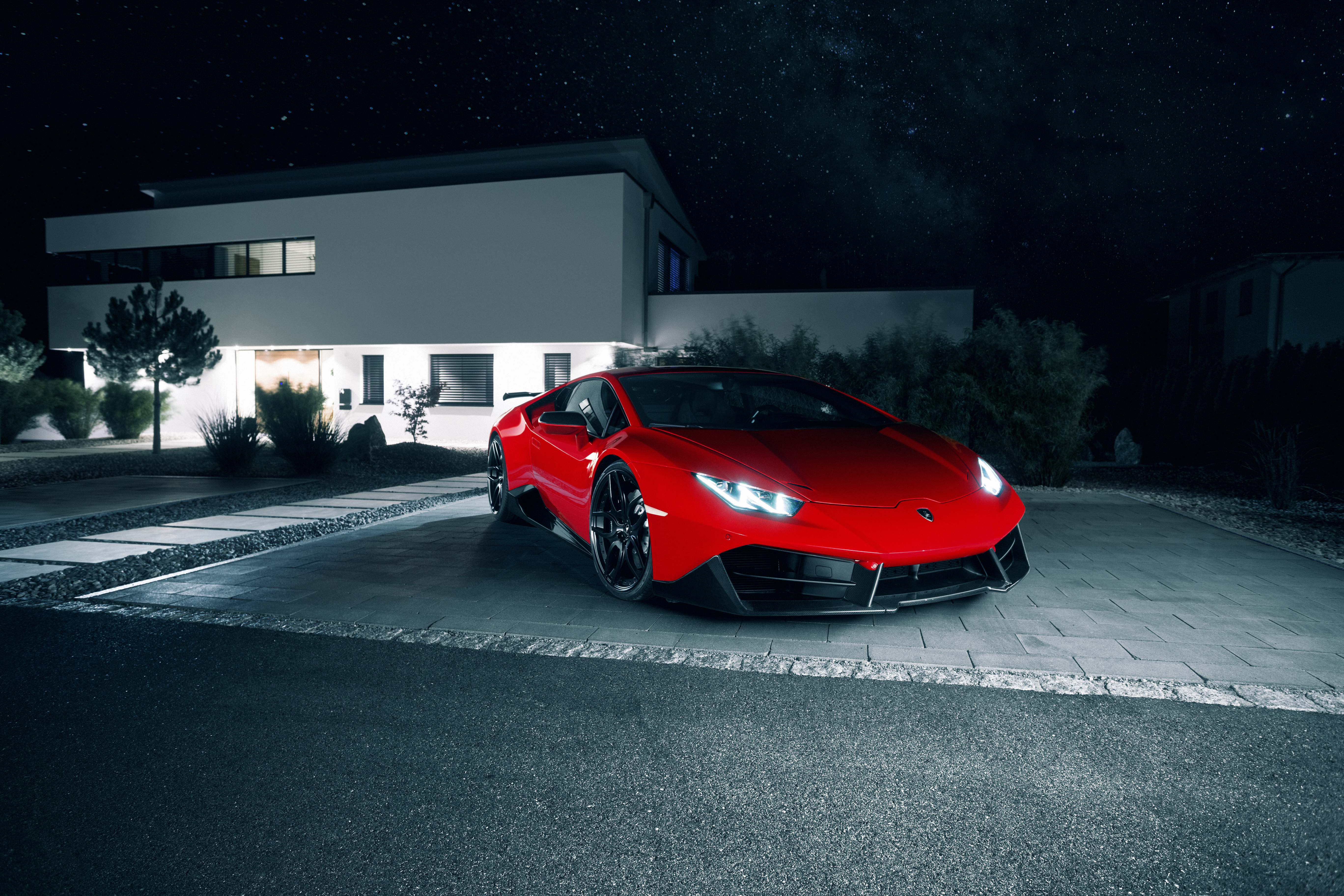Red Lamborghini Huracan parked in front of a modern house at night HD Wallpaper