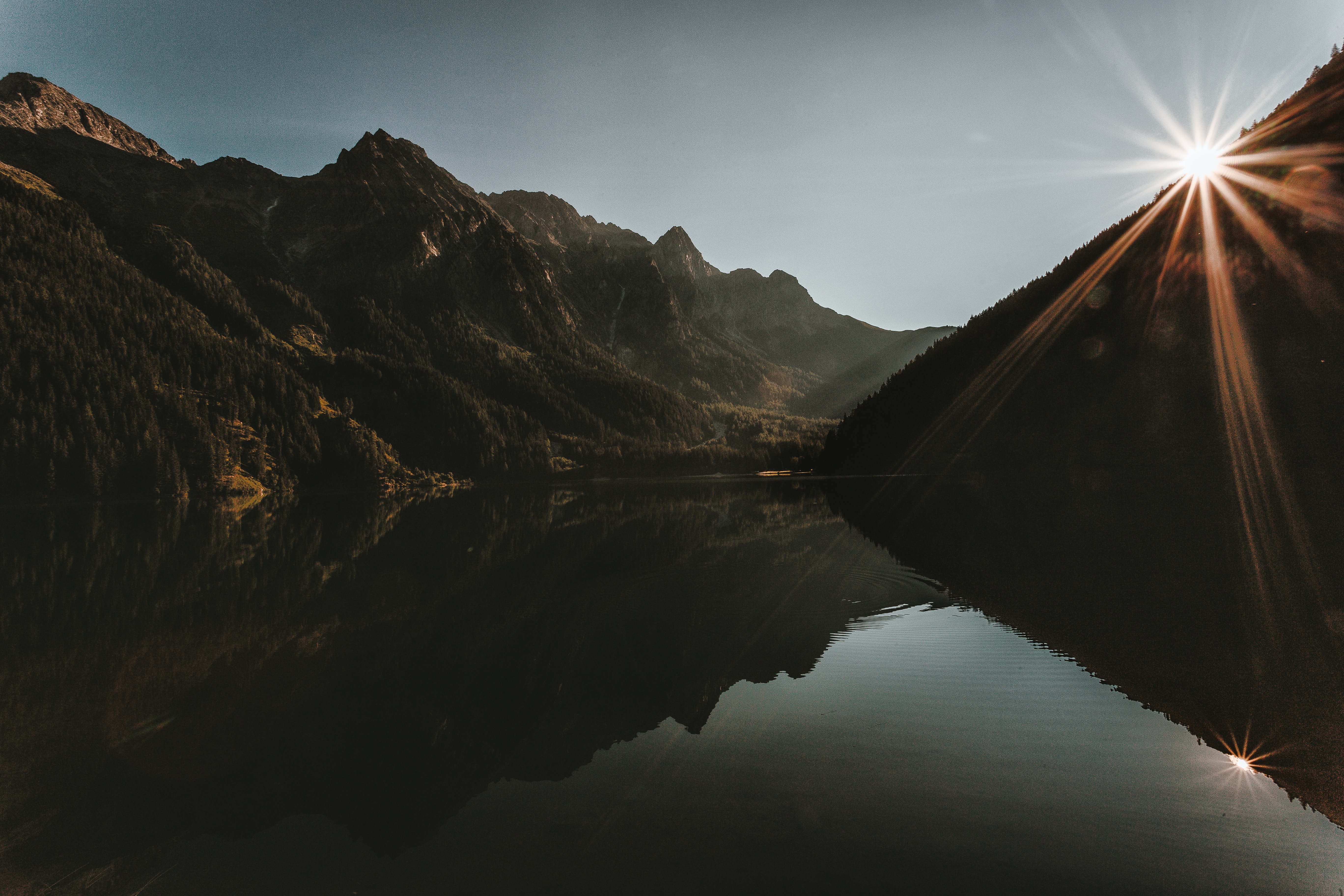 Mountains reflecting in a lake at sunrise HD Wallpaper