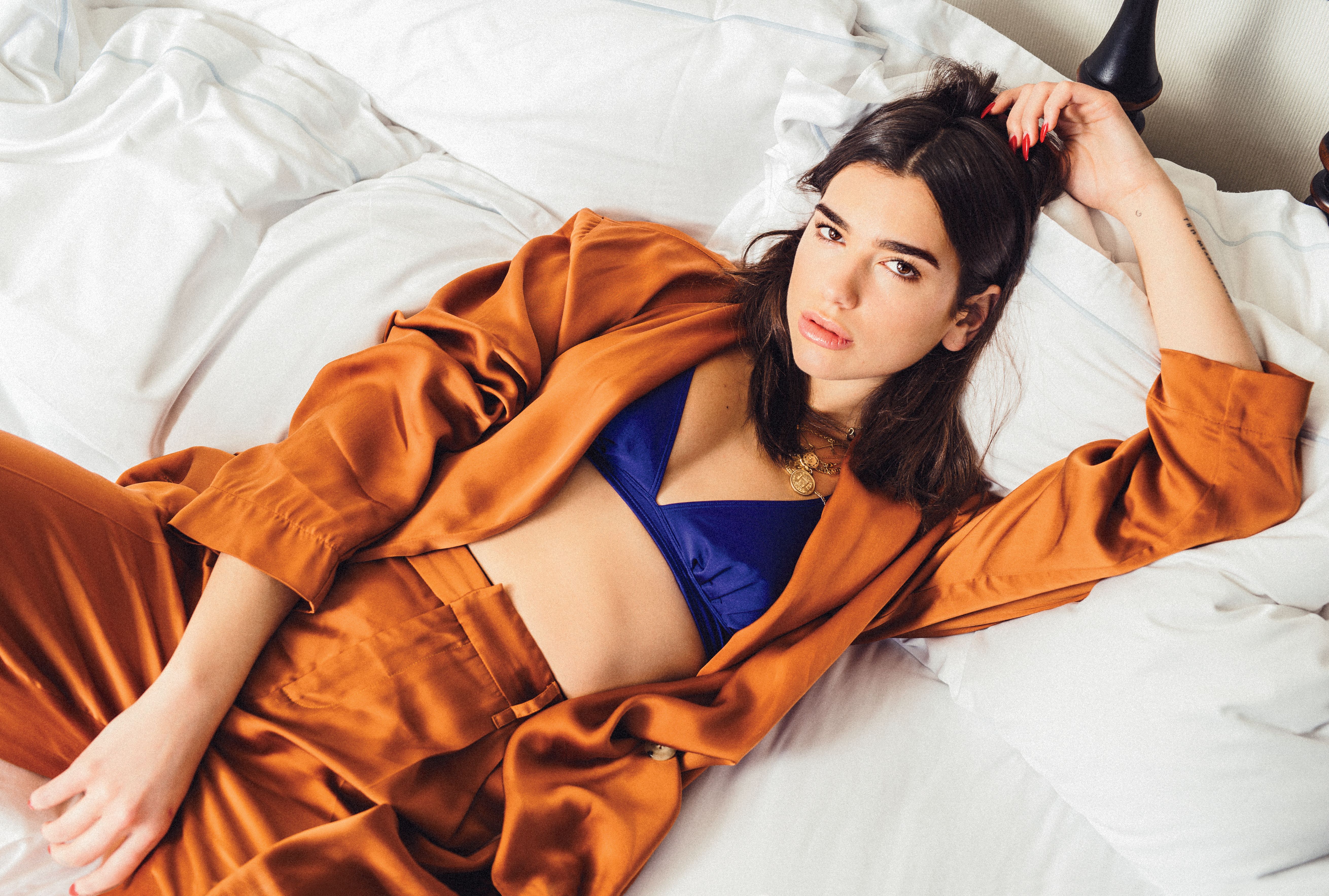 Dua Lipa in orange suit and blue bra HD Wallpaper